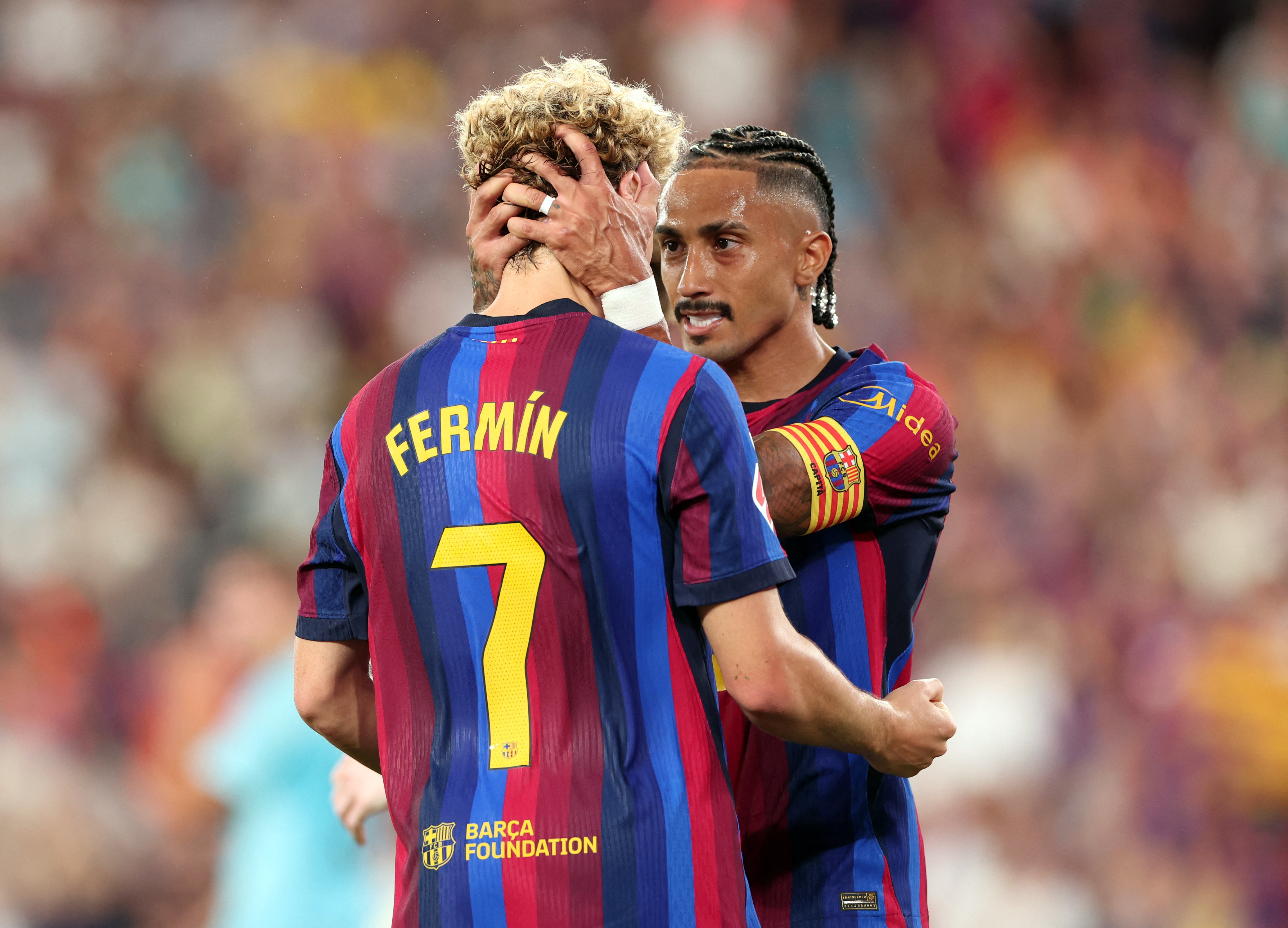 Barcelona's Raphinha celebrates scoring their first goal with Fermin Lopez