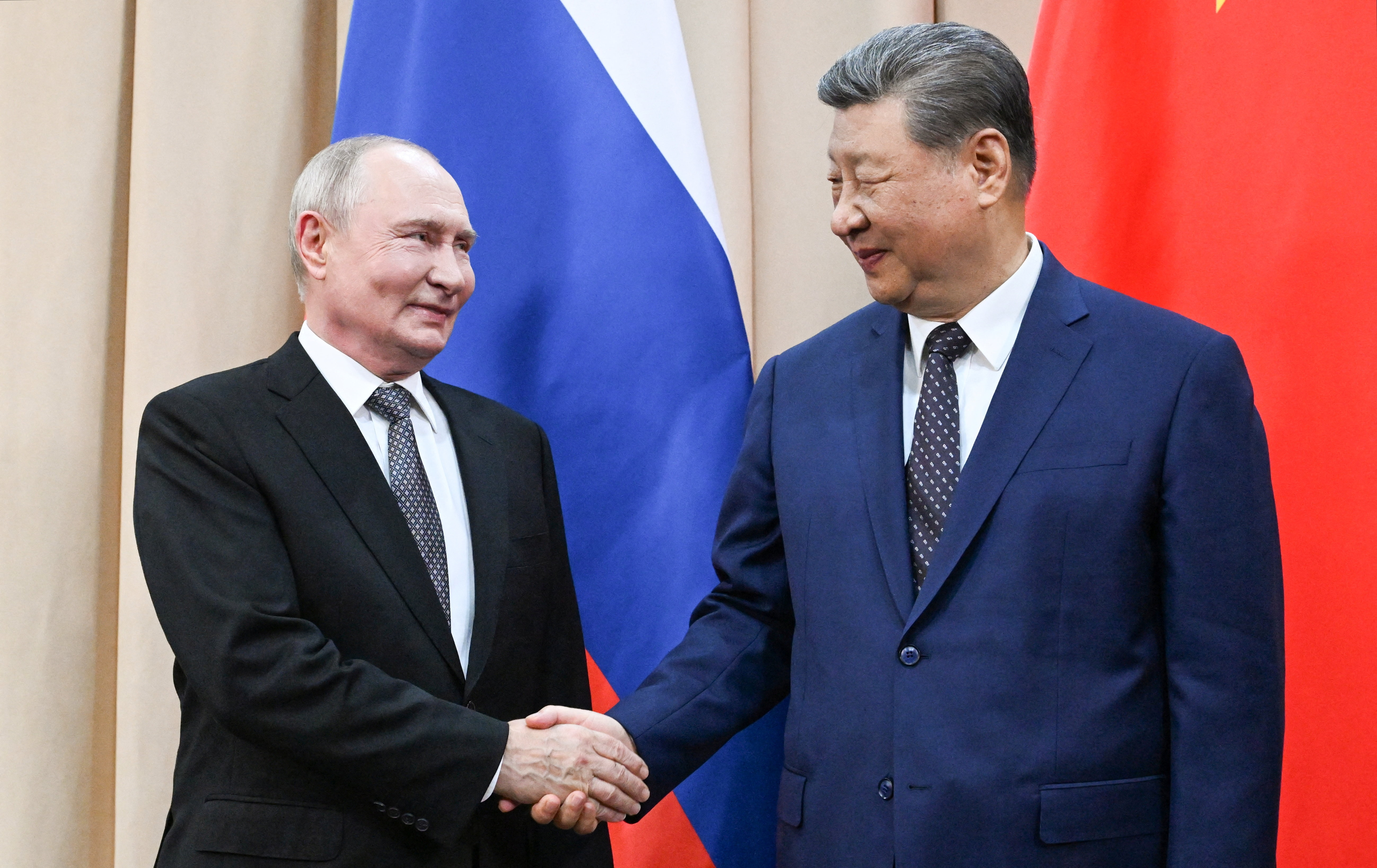 Russian President Vladimir Putin and Chinese President Xi Jinping shake hands during a meeting on the sidelines of the Shanghai Cooperation Organisation summit in Bishkek, Kyrgyzstan, on August 31, 2026. [Pool/Reuters]
