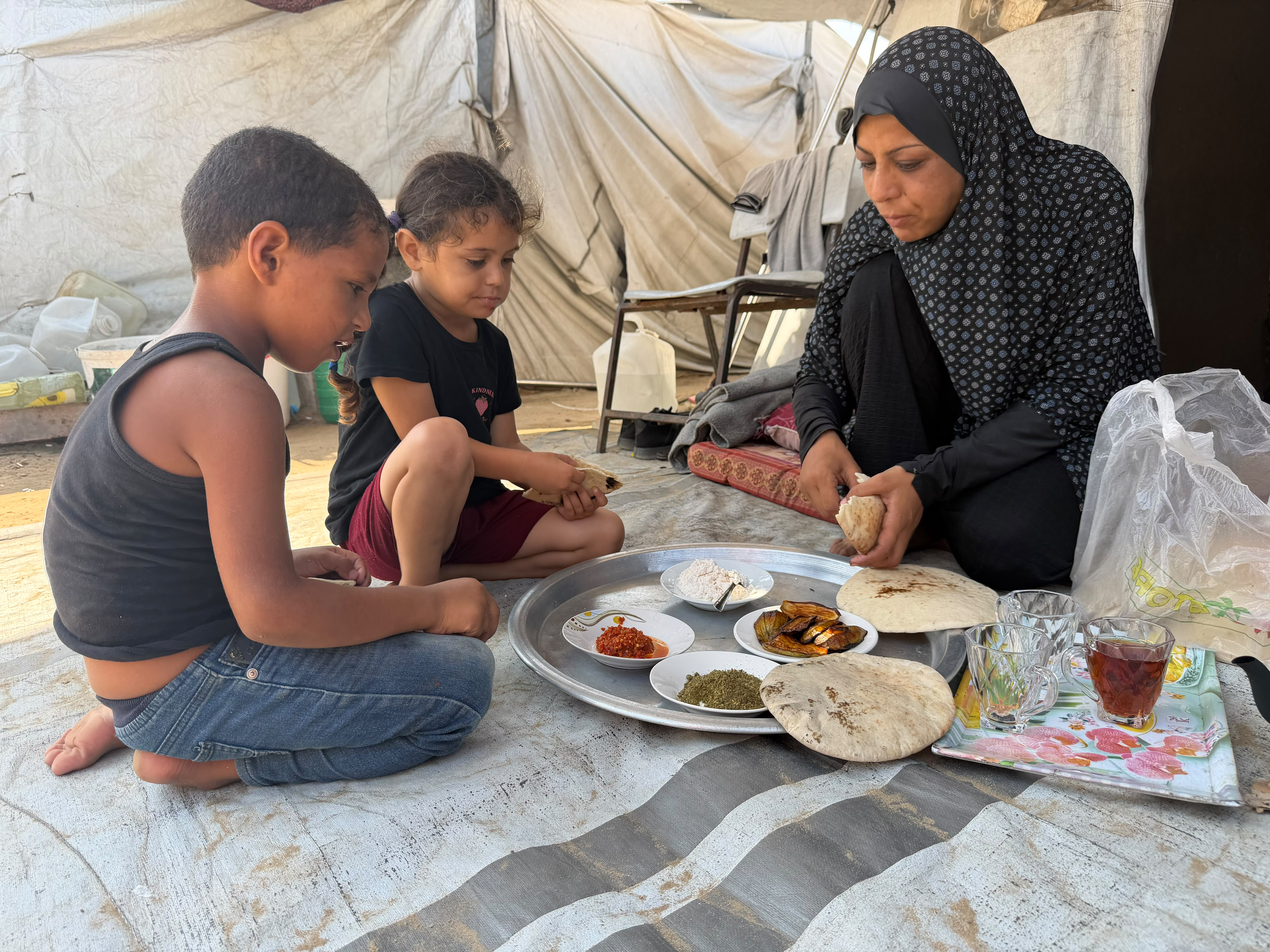 Woman with her two children eating