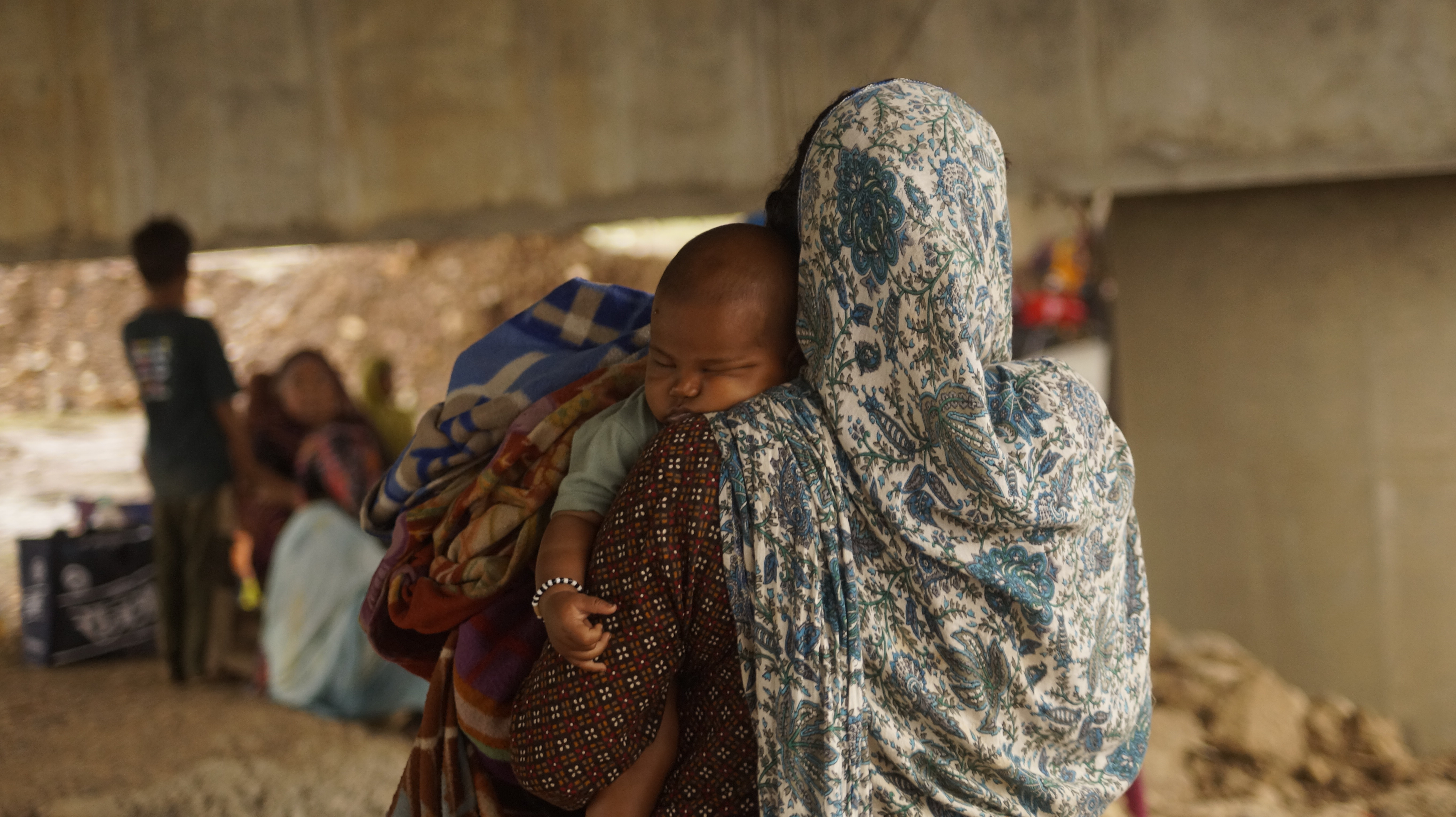 A woman holds a sleeping baby during the Chita Andolan protest near Kupi village in Madhya Pradesh
