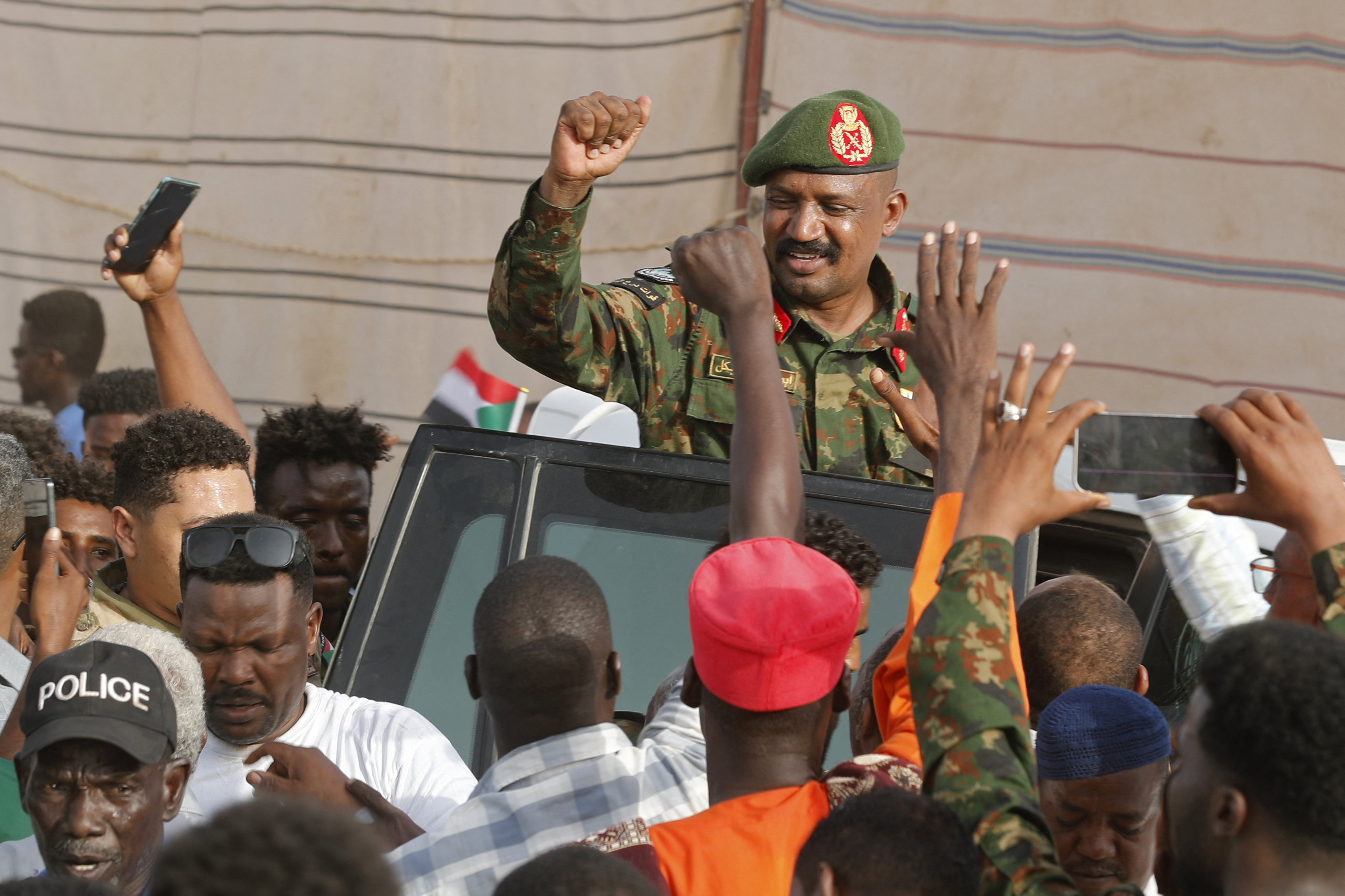 Sudanese military officer Abu Aqla Kaikal gestures to people upon his arrival to attend an event at the Family Club stadium in Khartoum on August 6, 2026. (Photo by Ebrahim HAMID / AFP)