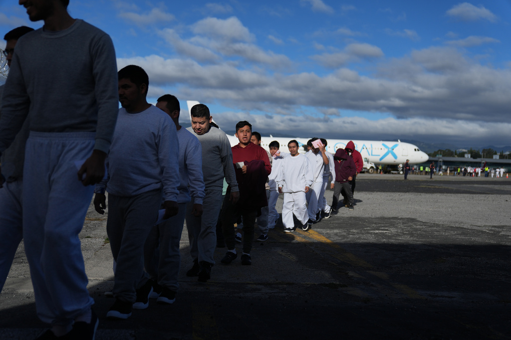 Guatemalan deportees exit a plane