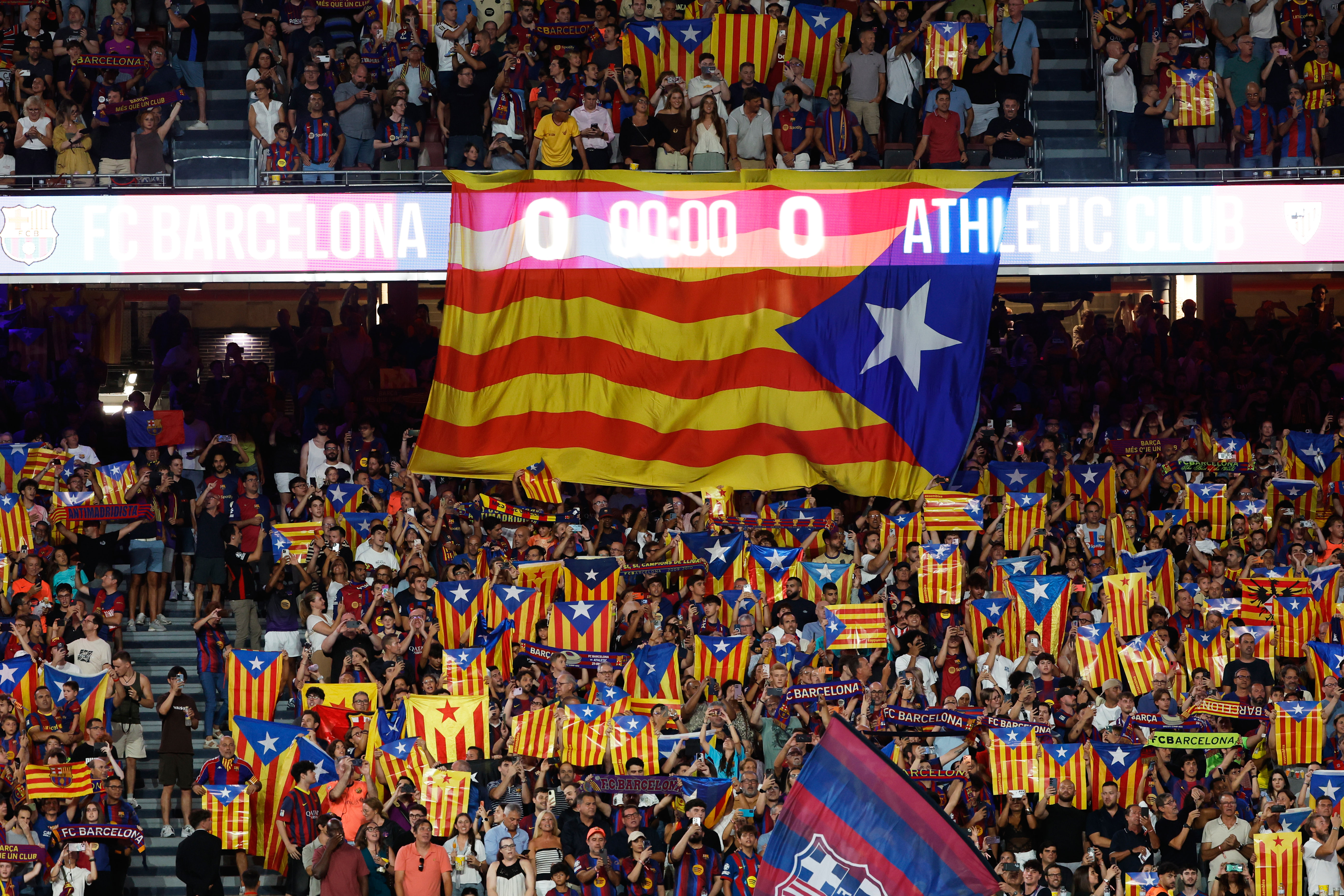 Supporters lift independence flags during a Spanish La Liga soccer match between Barcelona and Athletic