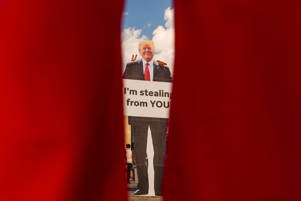 a cardboard cutout of Donald Trump at a protest