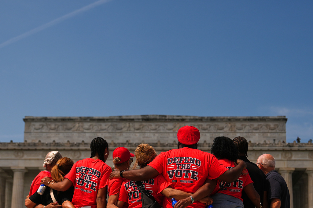 people stand in front of the Lincoln Memorial