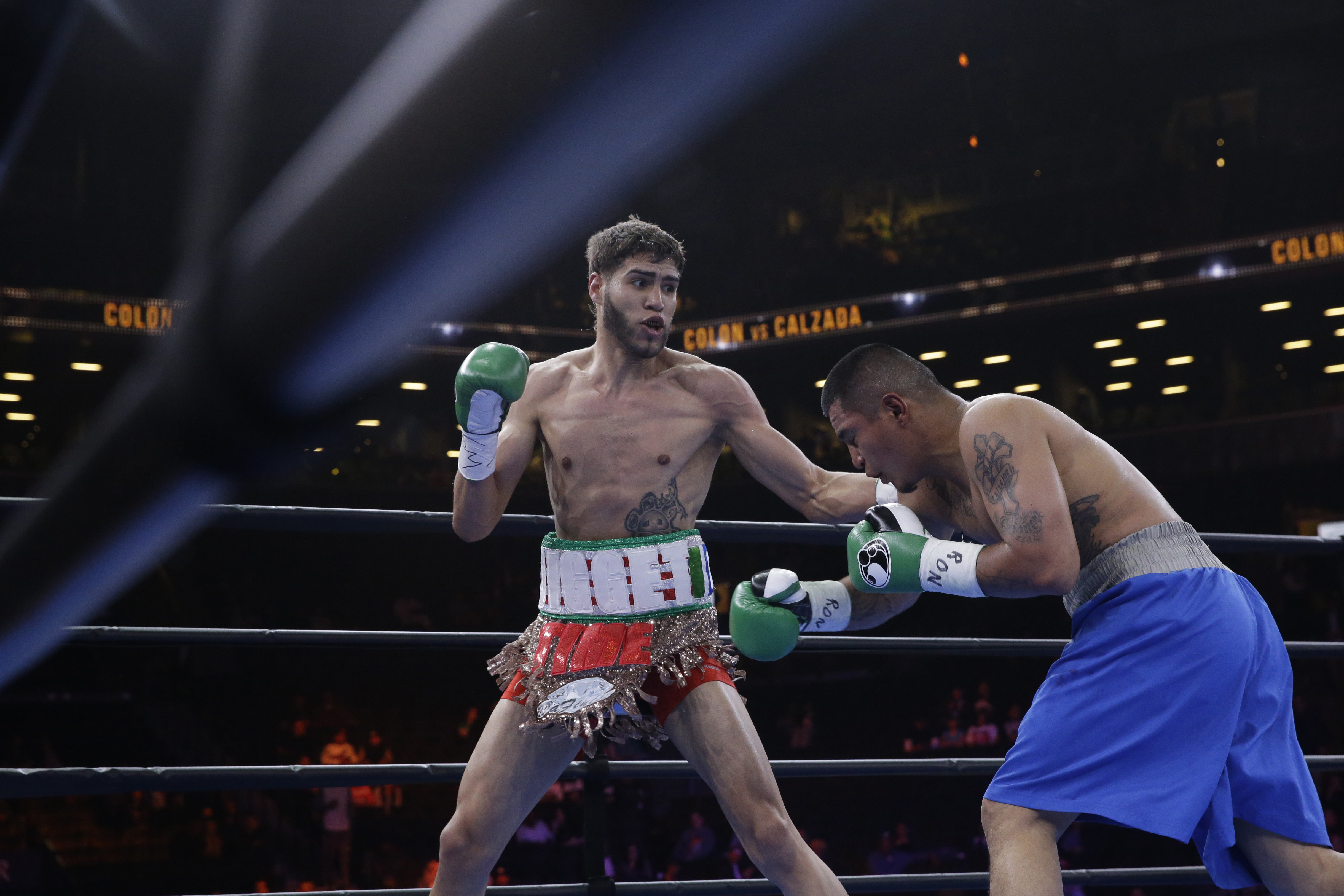 Prichard Colon, left, exchanges punches with Daniel Calzada during a junior middleweight title boxing match, Saturday, April 11, 2015, at New York