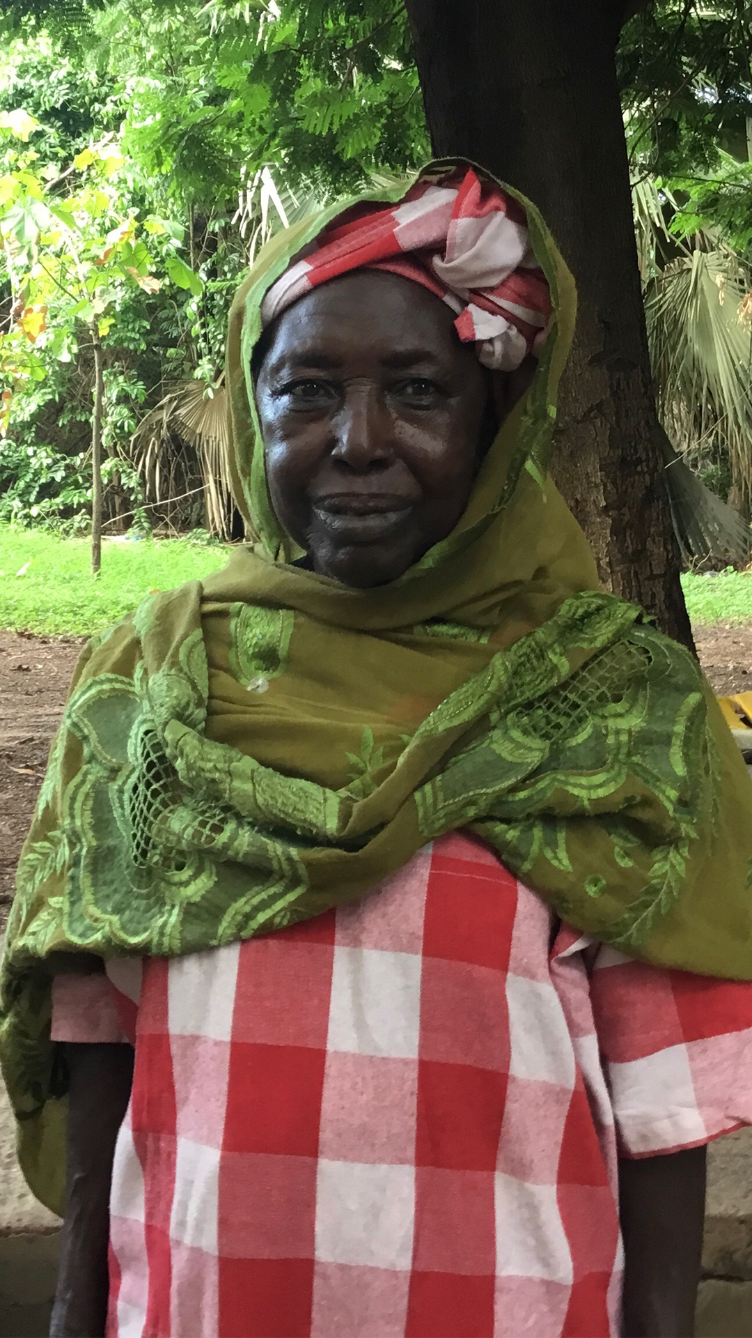 Nanding, 72, a member of the Kanyeleng group in Bakau, takes part in a Sunday gathering