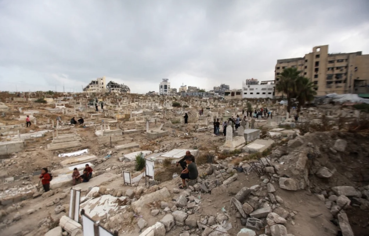 Deir al-Balah cemetery: Palestinians visiting the graves of their loved ones [Hisham Zano/Al Jazeera]