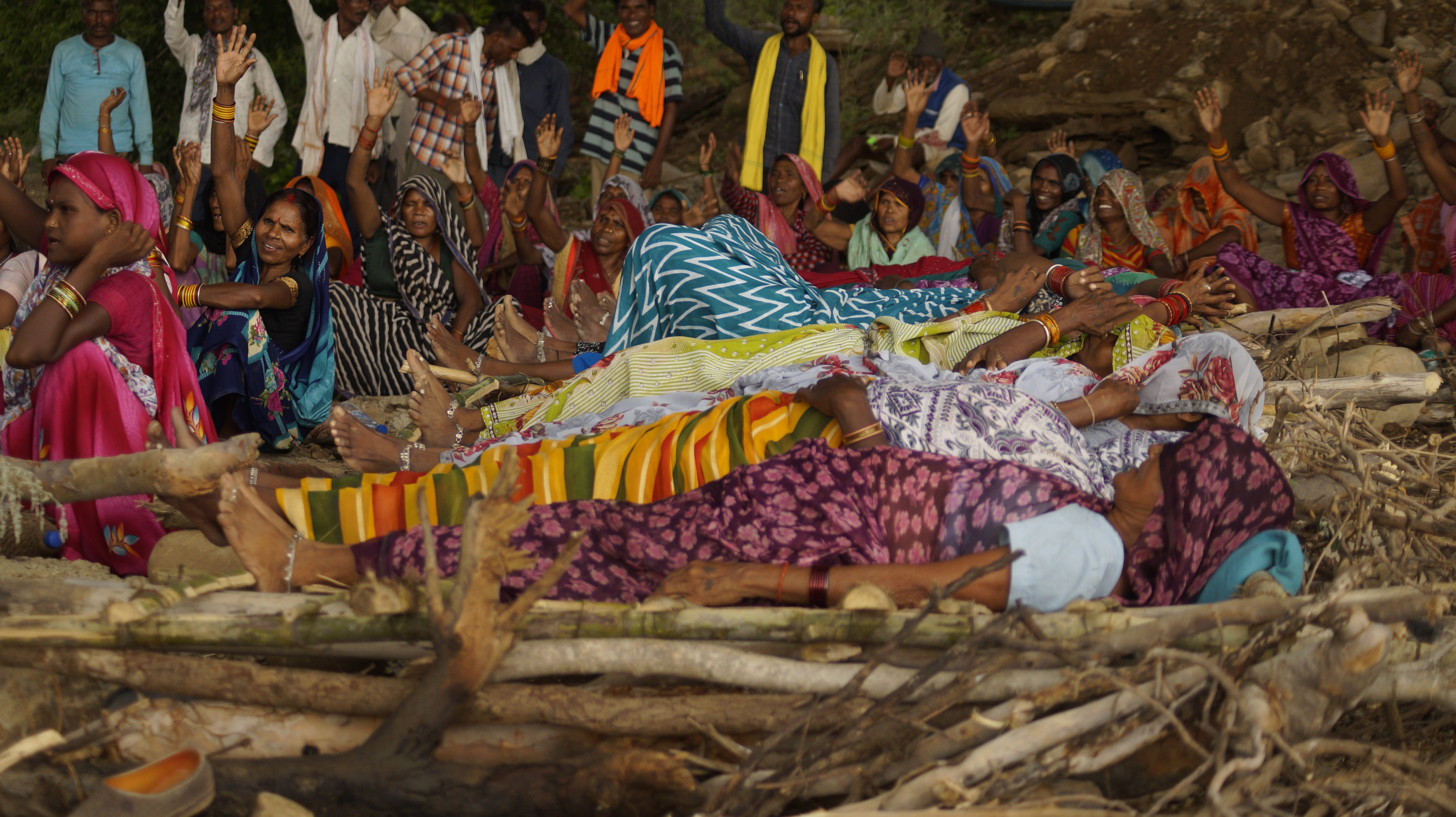 Women lie on unlit funeral pyres during the Chita Andolan protest near Kupi village, Madhya Pradesh