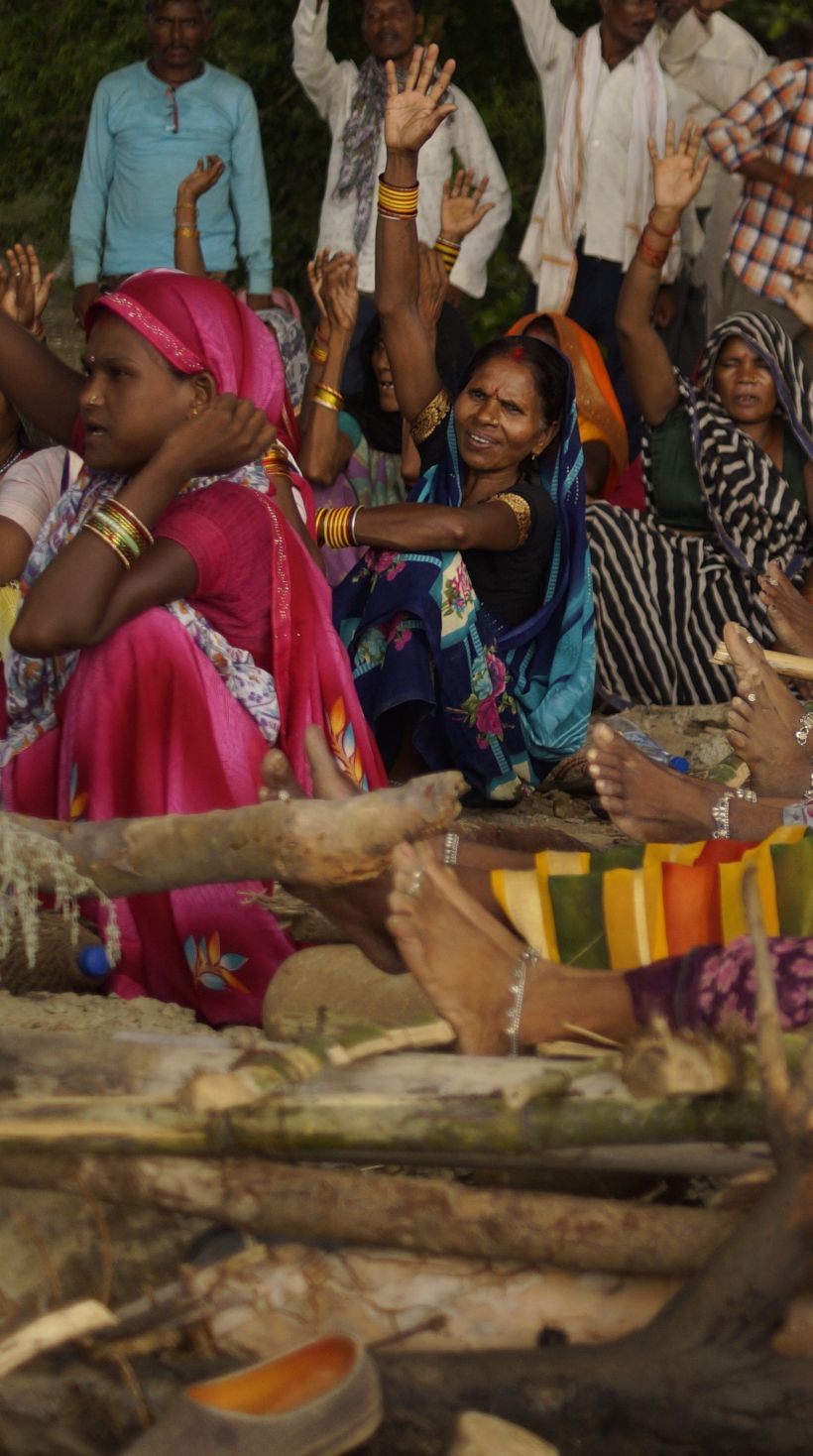 Women lie on unlit funeral pyres during the Chita Andolan protest near Kupi village, Madhya Pradesh