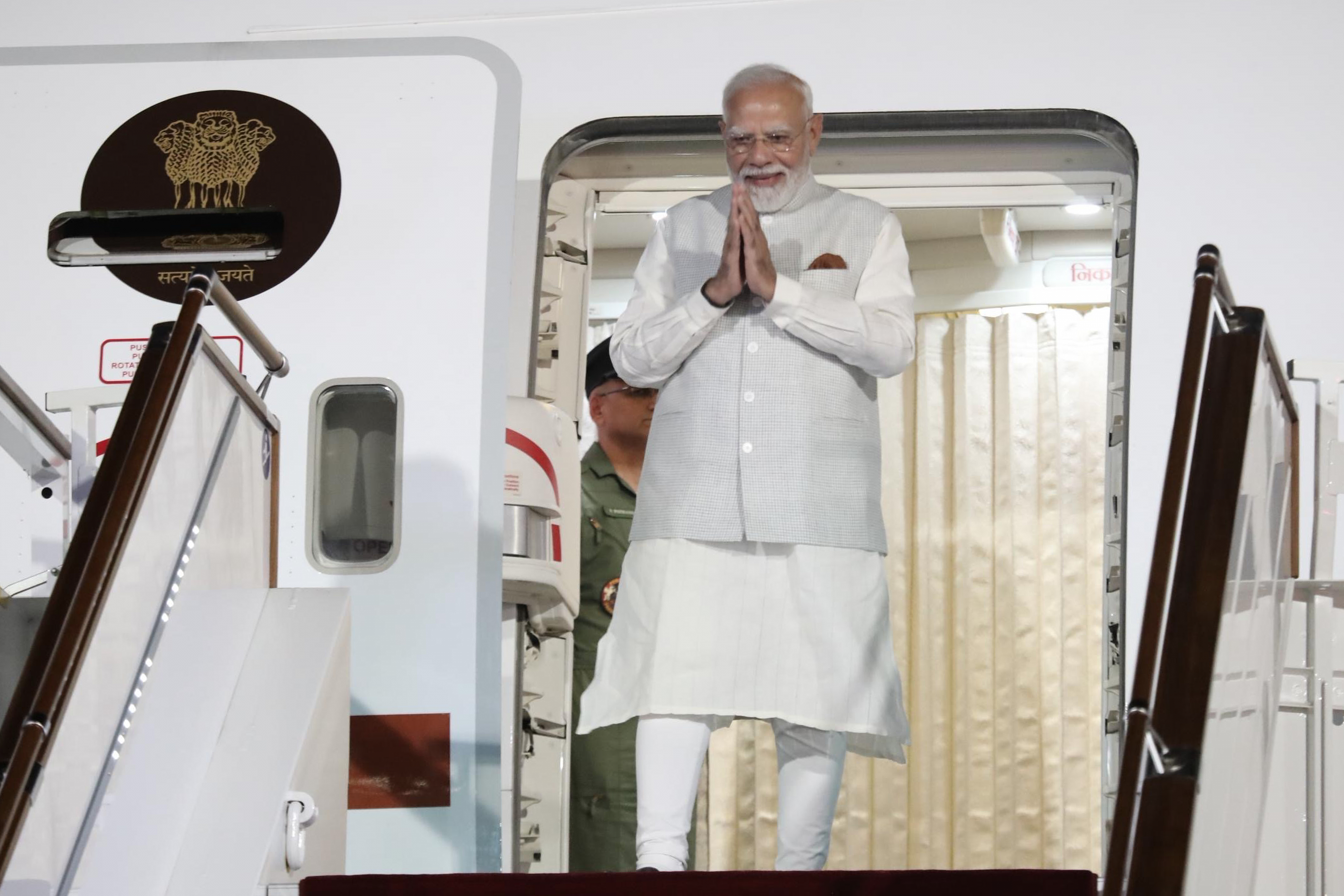 In this photo provided by Kyrgyzstan's Prime Minister Press Office, Indian Prime Minister Narendra Modi stands on the an aircraft boarding stairs upon his arrival at an international airport outside Bishkek, Kyrgyzstan, on Sunday, Aug. 30, 2026. (Ergesh Zhusubaiv/Kyrgyzstan's Presidential Press Office via AP)