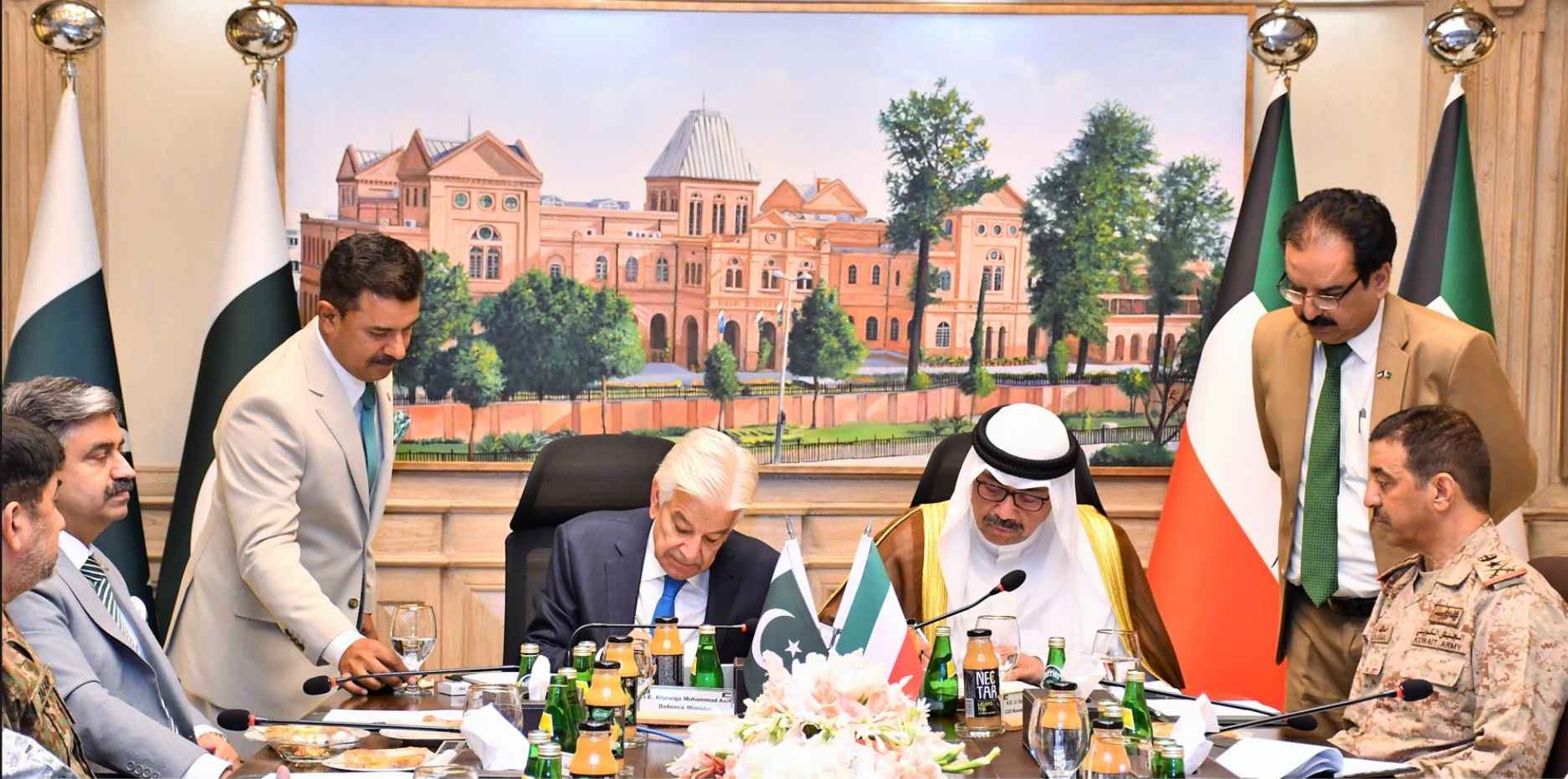 Pakistan's Defence Minister Khawaja Asif (2-L) and his Kuwaiti counterpart Sheikh Abdullah Ali Abdullah Al-Saleem Al-Sabah sign an agreement.