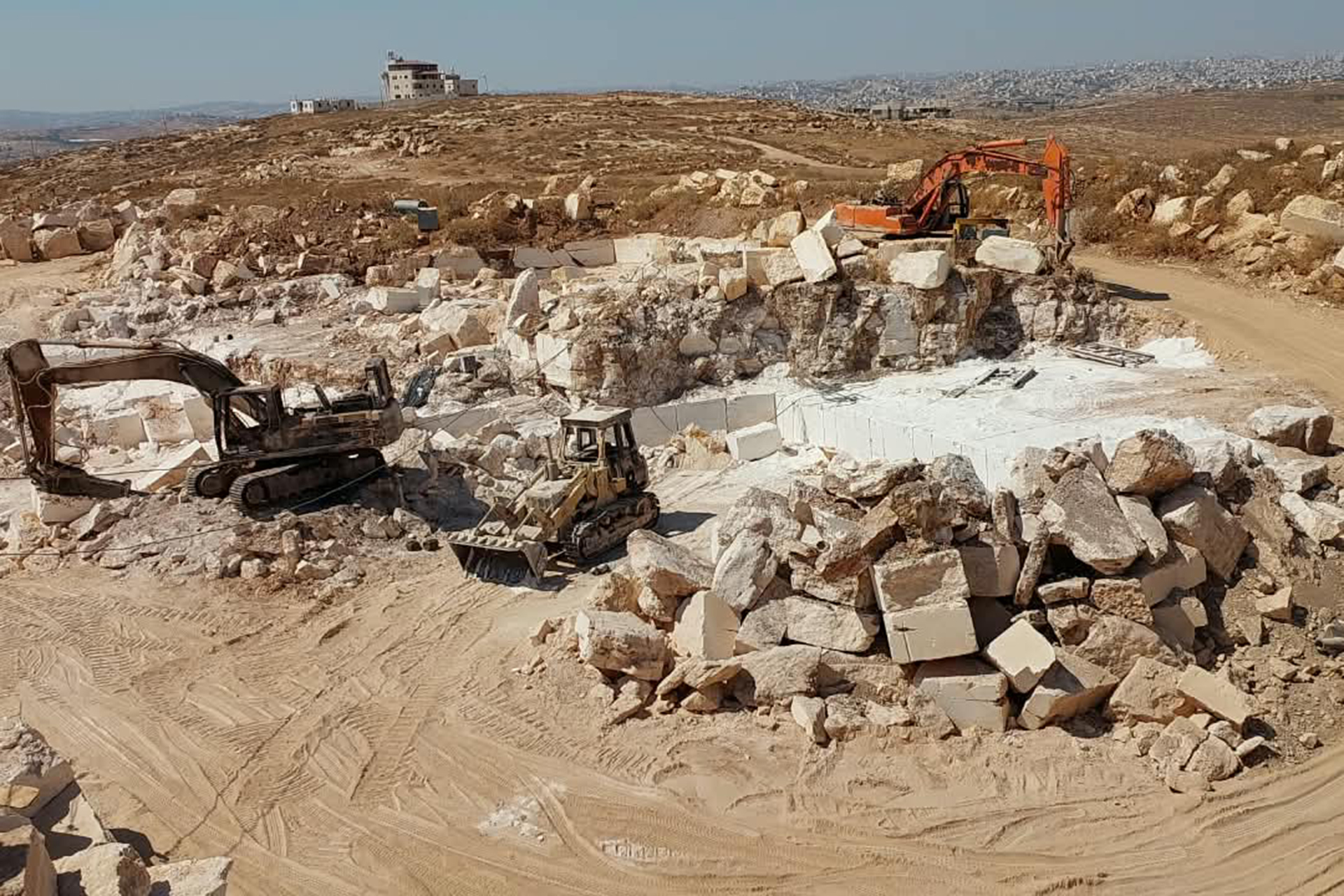 The stone quarry owned by Khaled Al-Zaarir in As-Samu remains out of operation after a devastating arson attack by Israeli settlers [Screengrab/Al Jazeera]