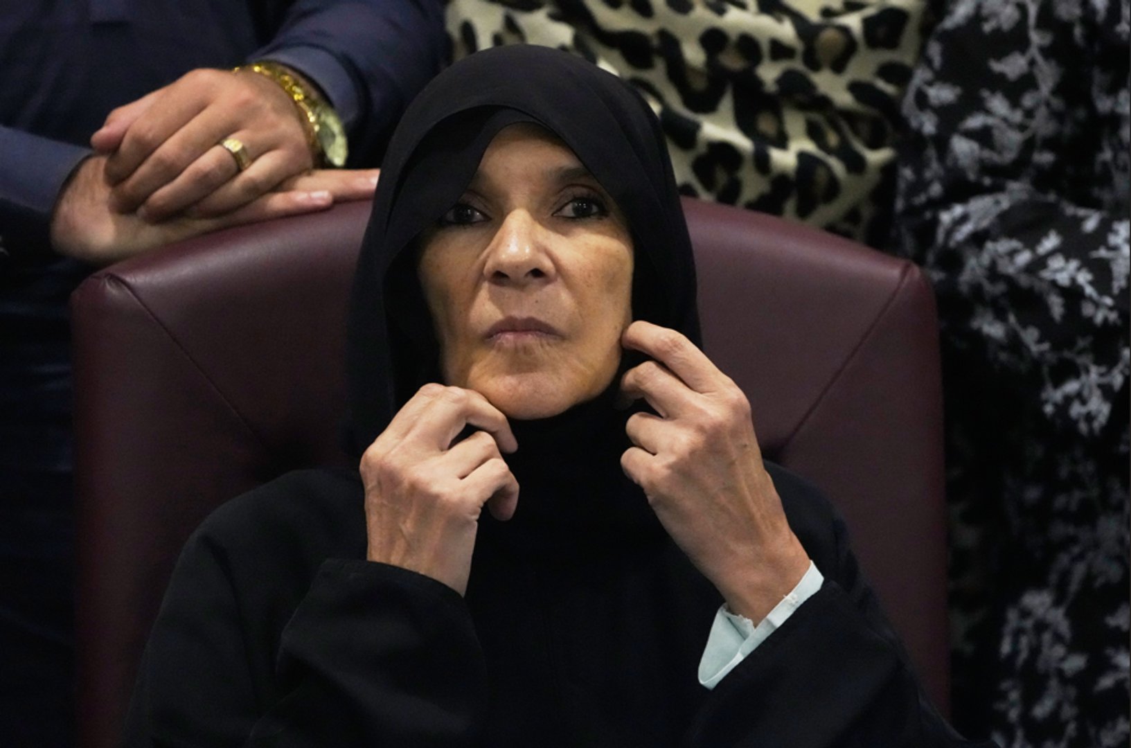 Former Pakistani Prime Minister Imran Khan's sister Uzma Khan adjusts her shawl during a press conference in Islamabad, Pakistan, Friday, Aug. 21, 2026. [AP Photo/Anjum Naveed]