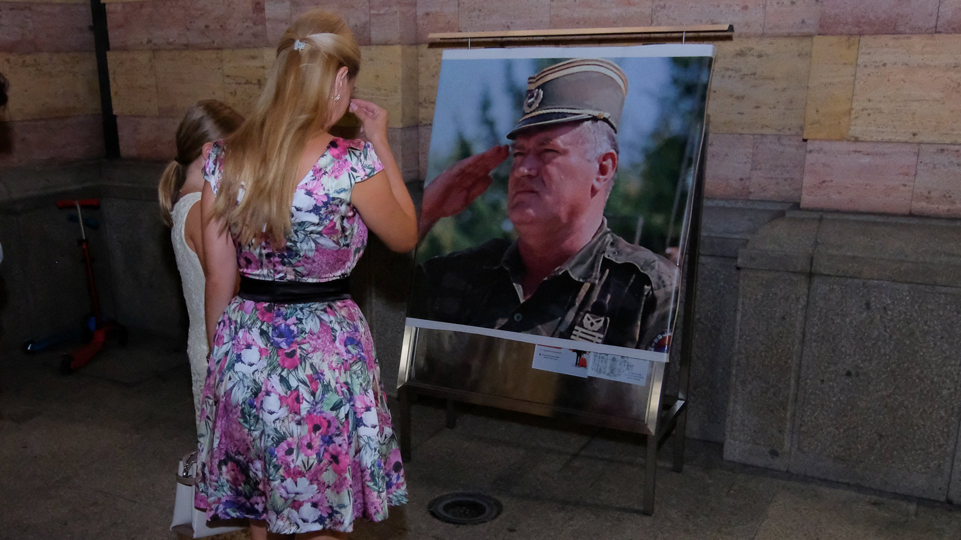 People react in front of the picture of the deceased Bosnian Serb general Ratko Mladic outside the Orthodox Cathedral Christ the Savior in Banja Luka, Bosnia and Herzegovina, August 27, 2026. [REUTERS]