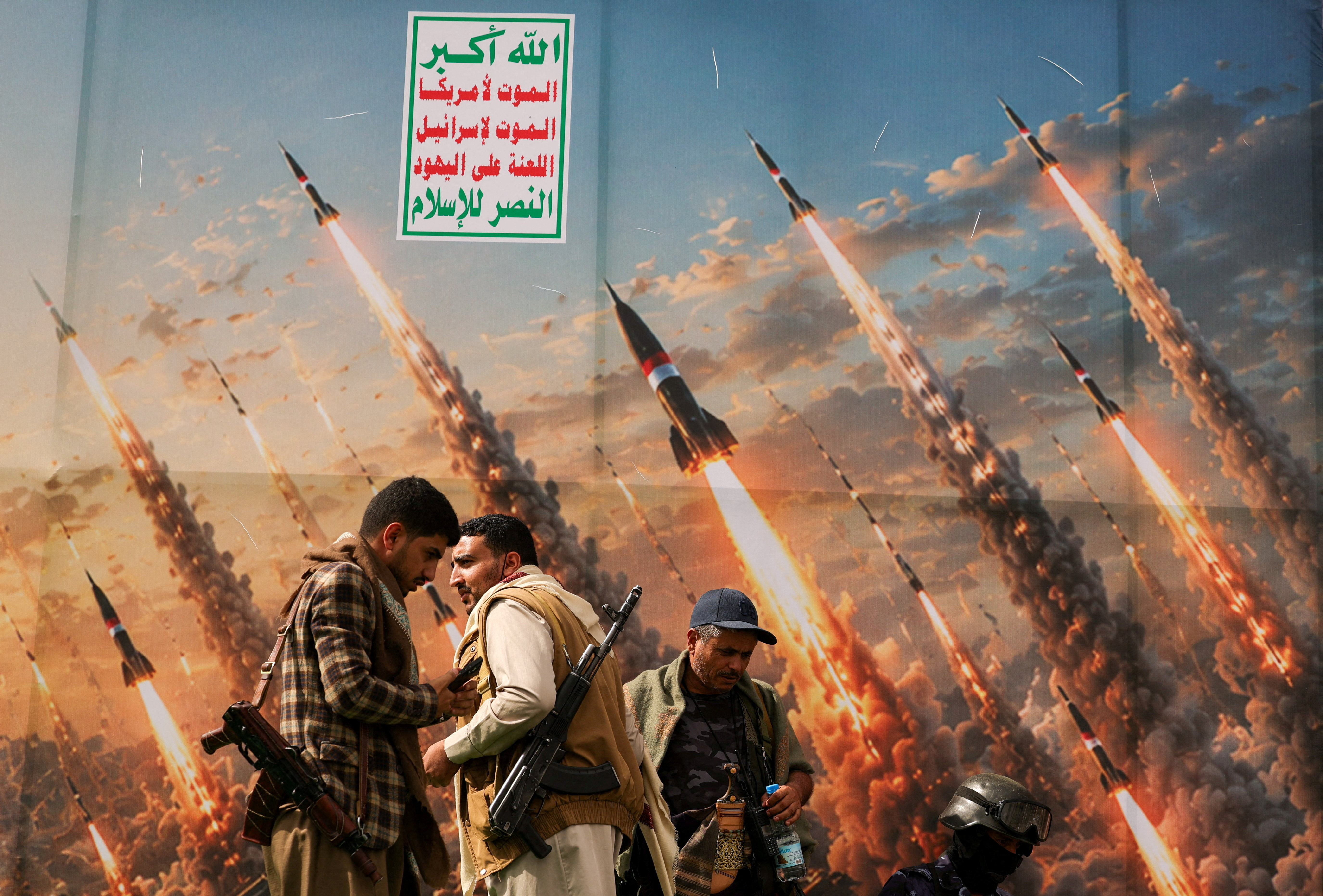 Houthi activists stand on a platform against a banner depicting Houthi missiles, at an anti-Saudi rally amid an escalation with the kingdom, in Sanaa, Yemen, July 31, 2026. REUTERS/Khaled Abdullah TPX IMAGES OF THE DAY