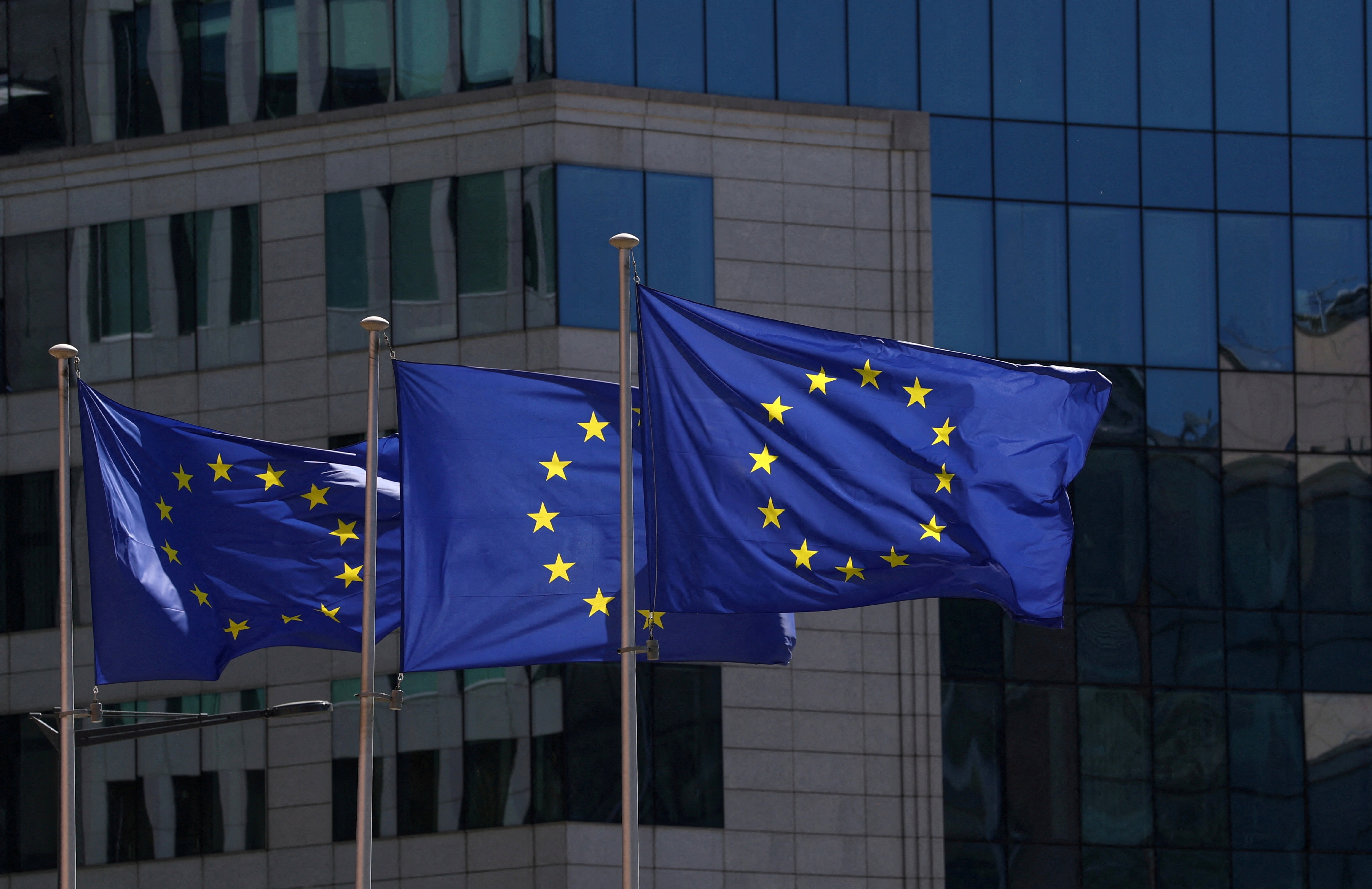 European Union flags flutter outside the European Commission headquarters in Brussels, Belgium.