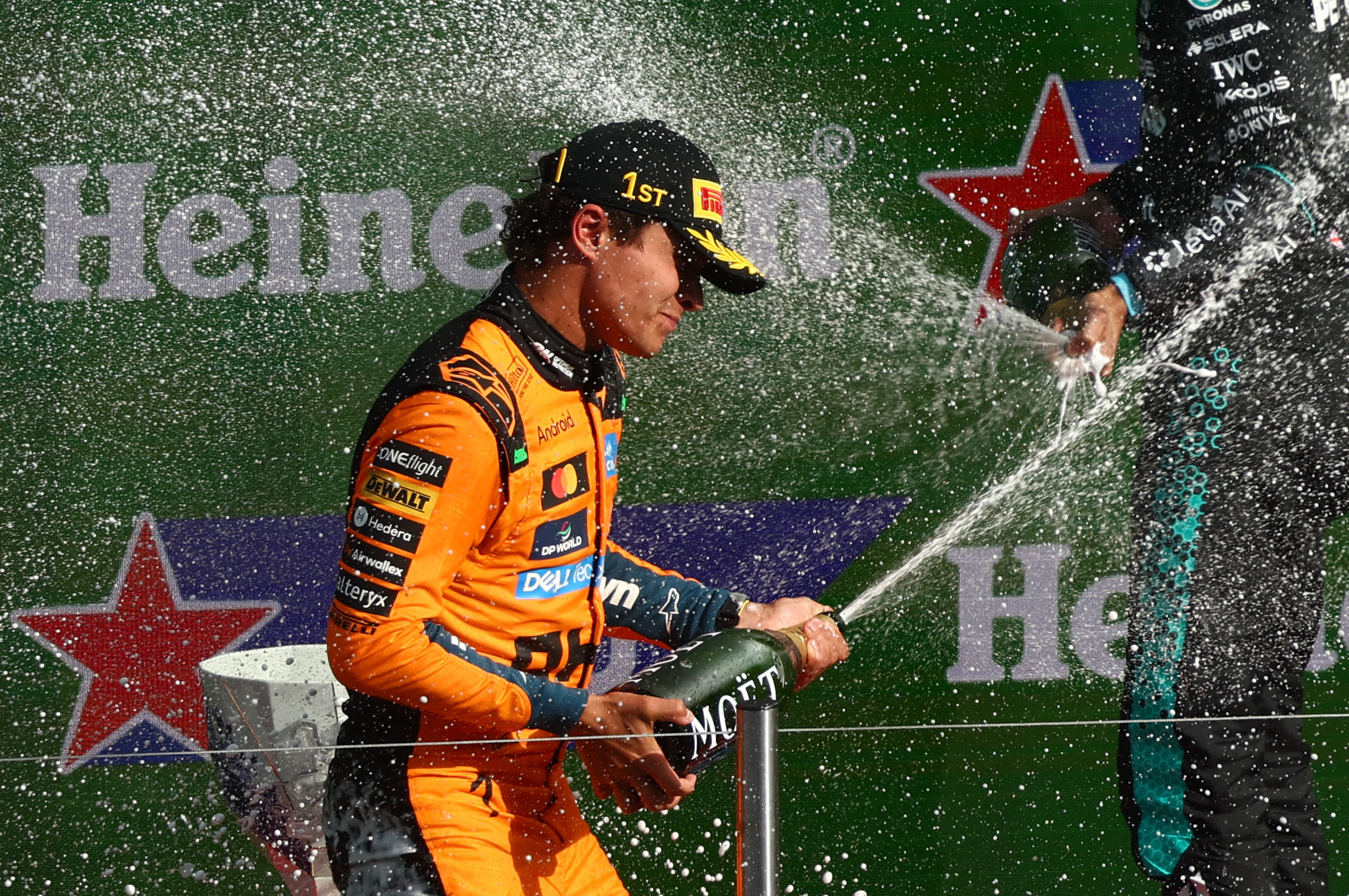 Formula One F1 - Dutch Grand Prix - Circuit Zandvoort, Zandvoort, Netherlands - August 23, 2026 McLaren's Lando Norris celebrates with champagne on the podium after winning the Dutch Grand Prix REUTERS/Jakub Porzycki