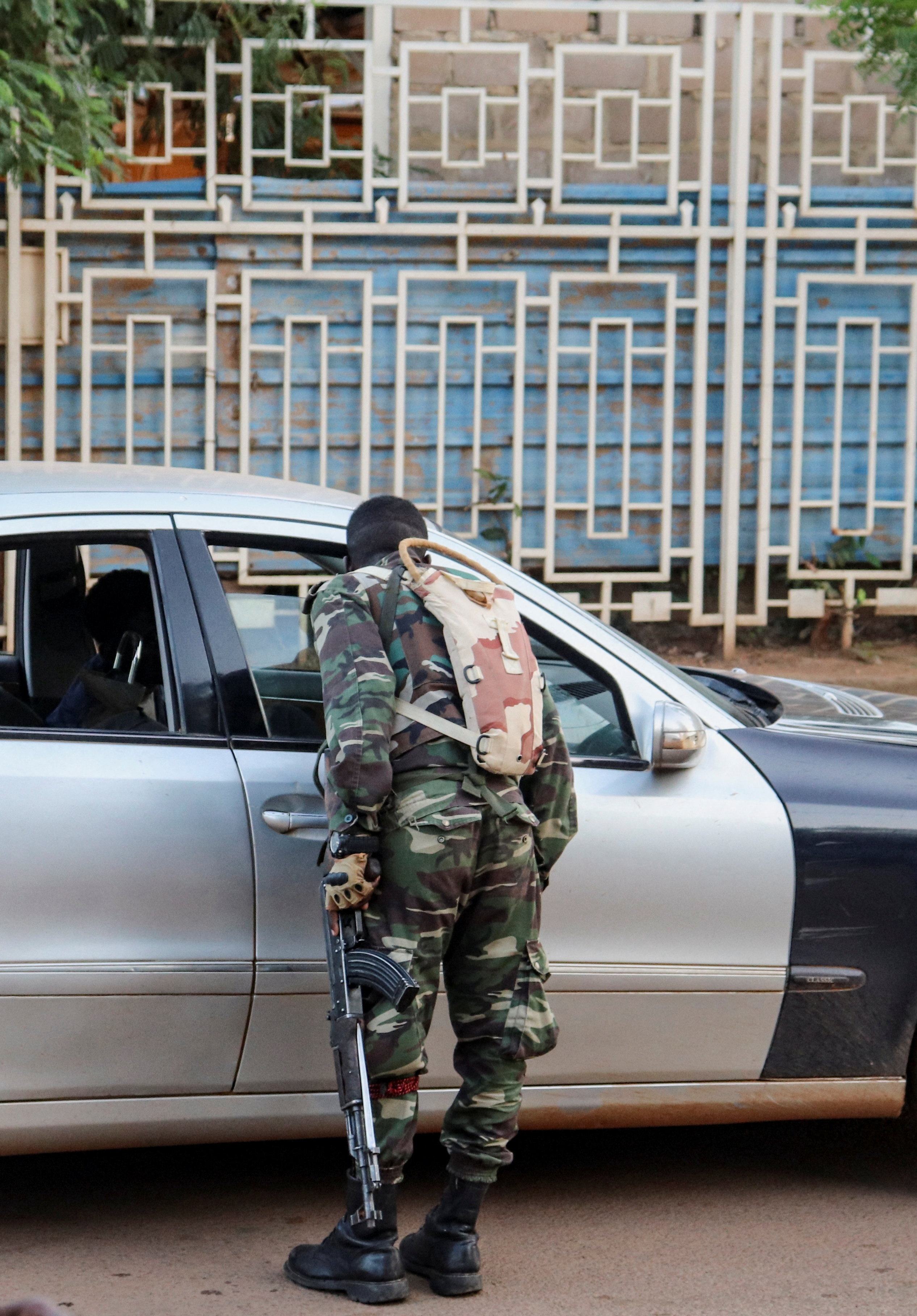 A soldier checks a vehicle at a roadside checkpoint following a mutineers' attack on the airport and the presidency in Niamey, Niger, August 29, 2026. REUTERS/Stringer