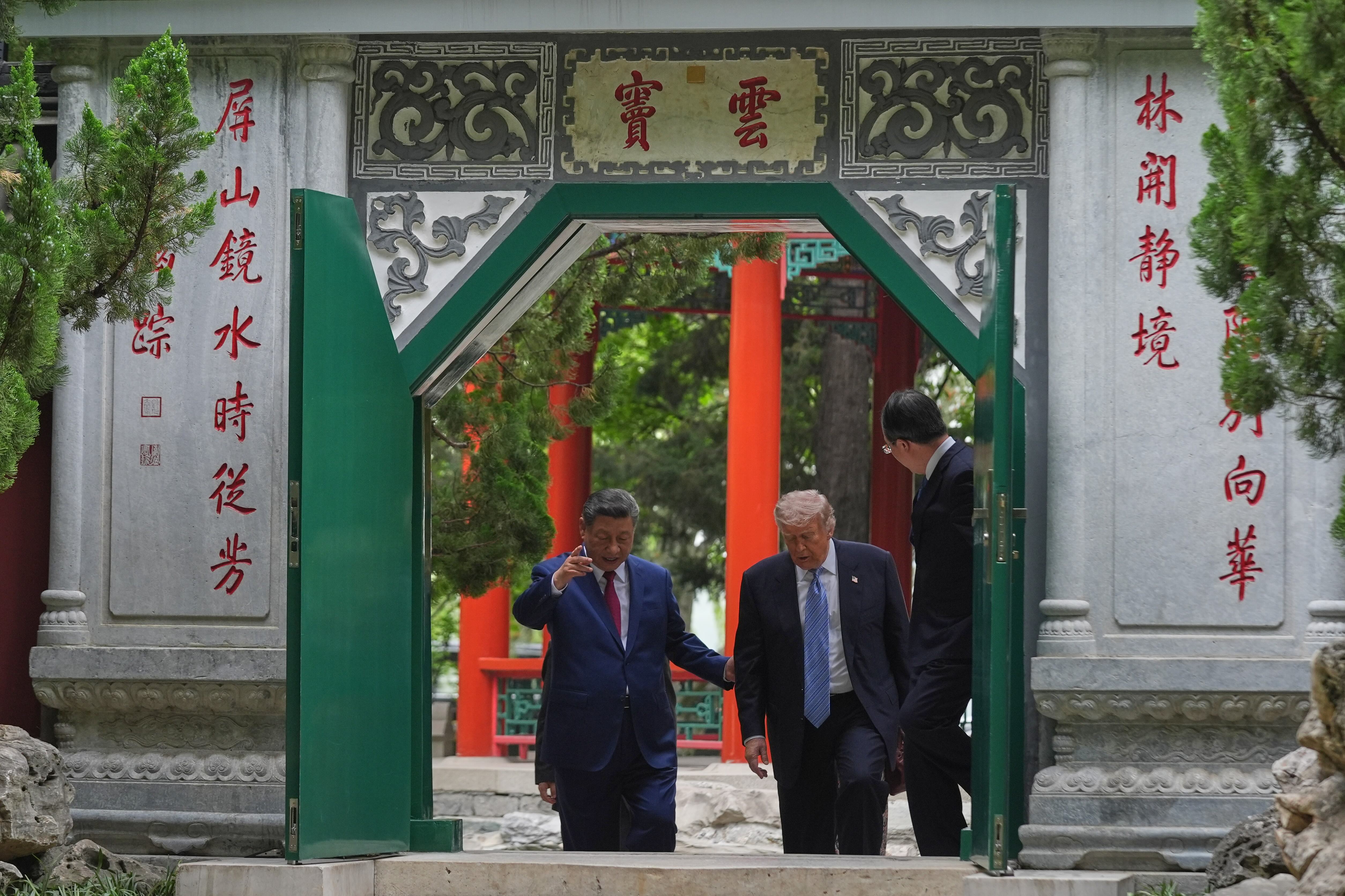 US President Donald Trump walks with China’s President Xi Jinping at the Zhongnanhai leadership compound, in Beijing, China, on May 15, 2026
