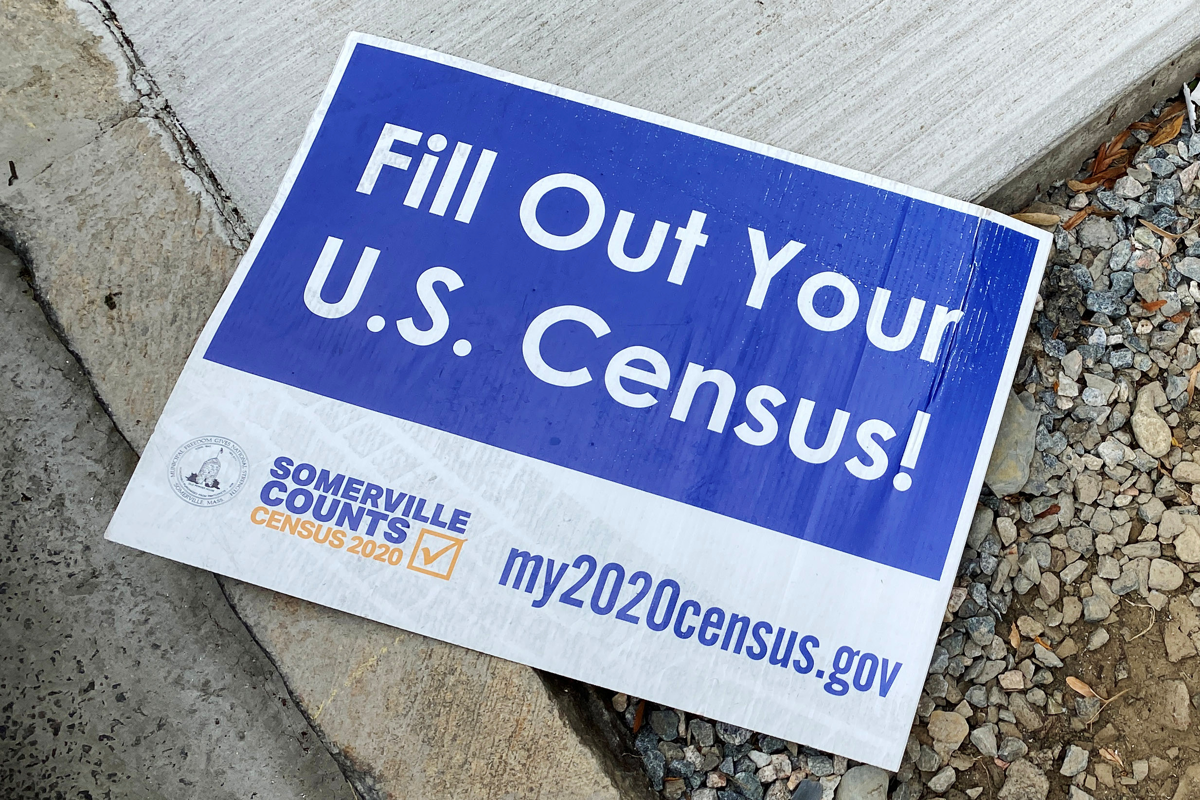 A sign encouraging participation in the U.S. Census lies on a sidewalk in Somerville, Massachusetts, U.S., August 4, 2020. REUTERS/Brian Snyder