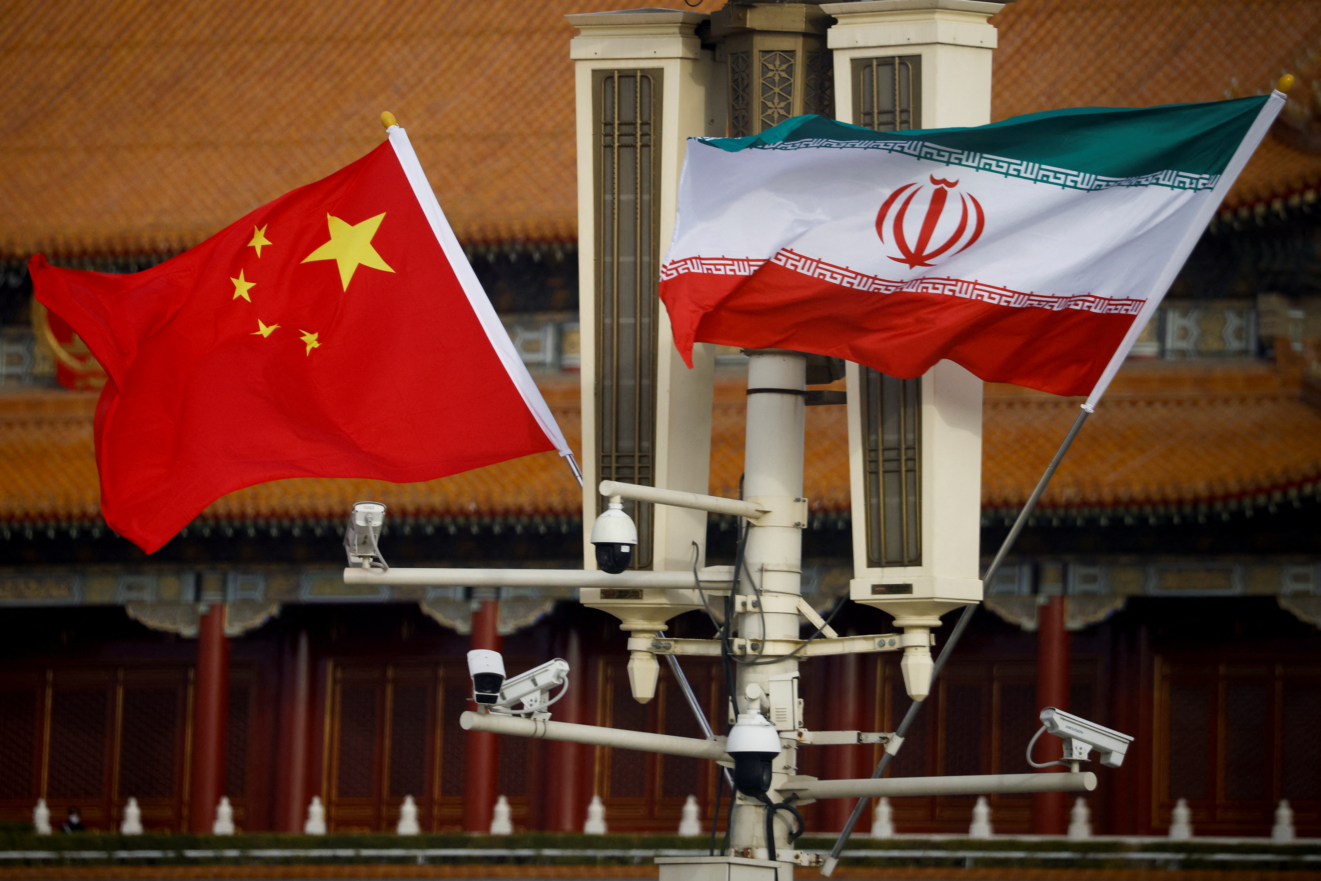 The national flags of China and Iran fly in Tiananmen Square.