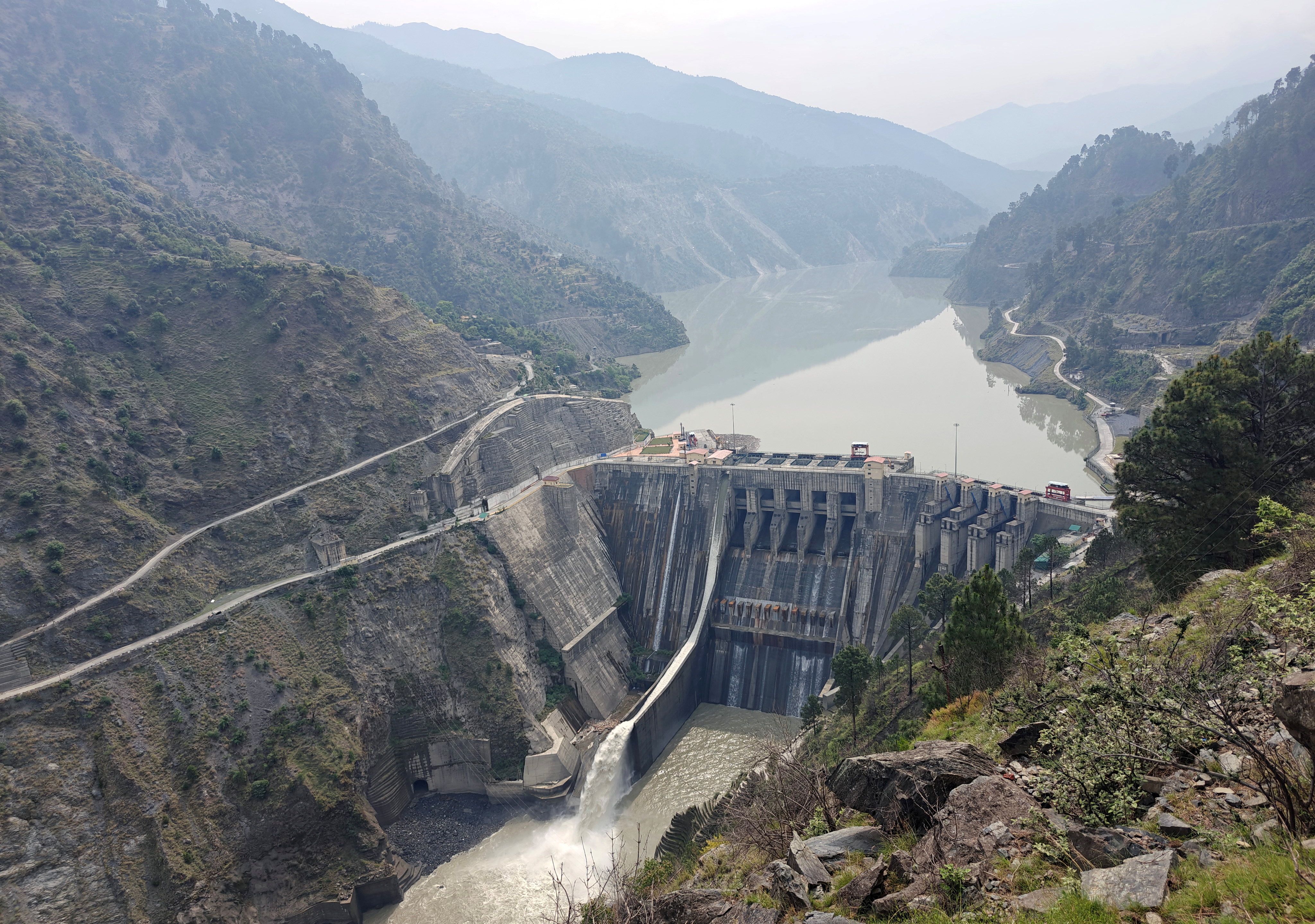 A view of a dam surrounded by hills.