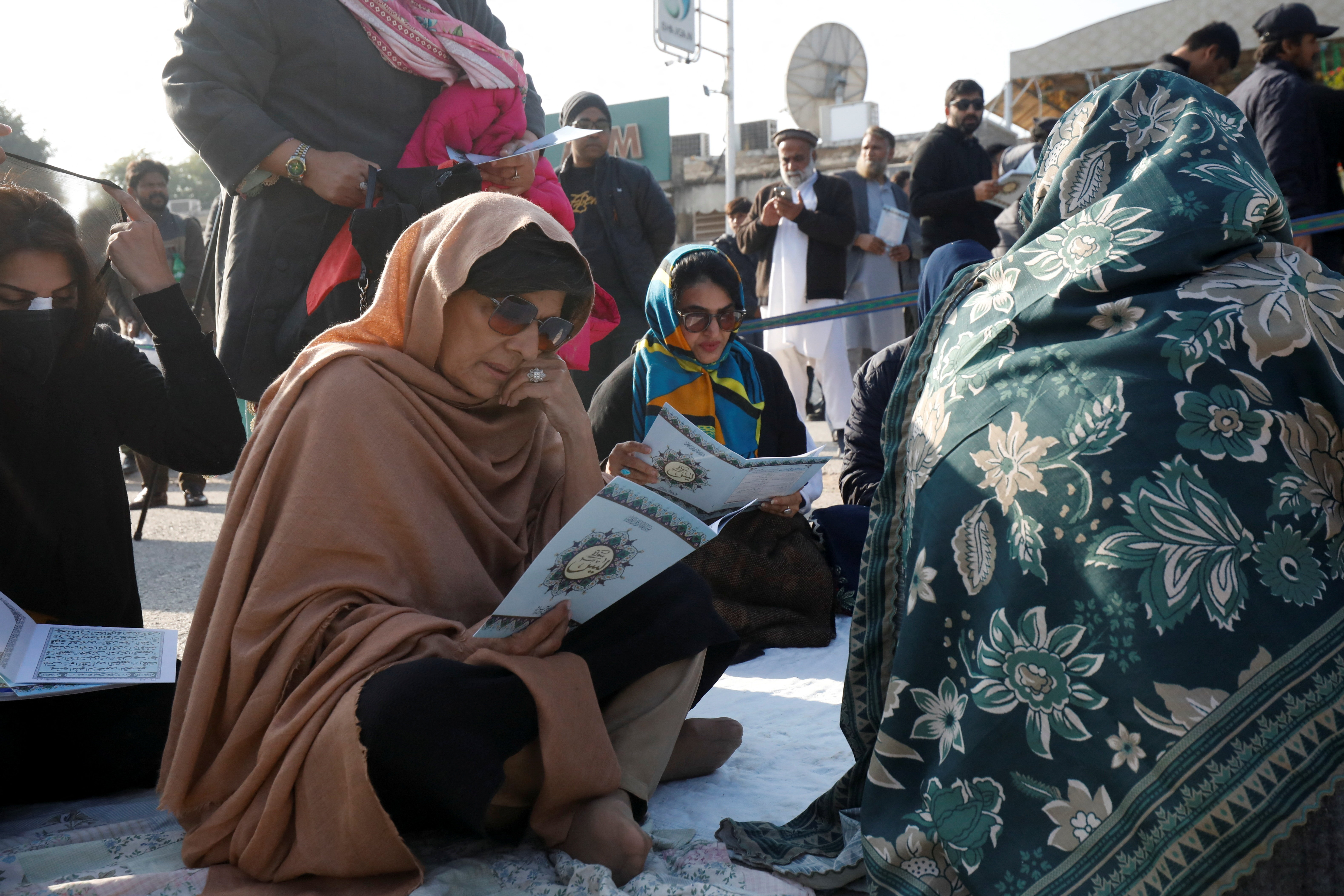 Aleema Khan, sister of jailed former Prime Minister Imran Khan, along with supporters, reads the Quran as they gather in protest on a road leading to Adiala jail in Rawalpindi, Pakistan, January 6, 2026