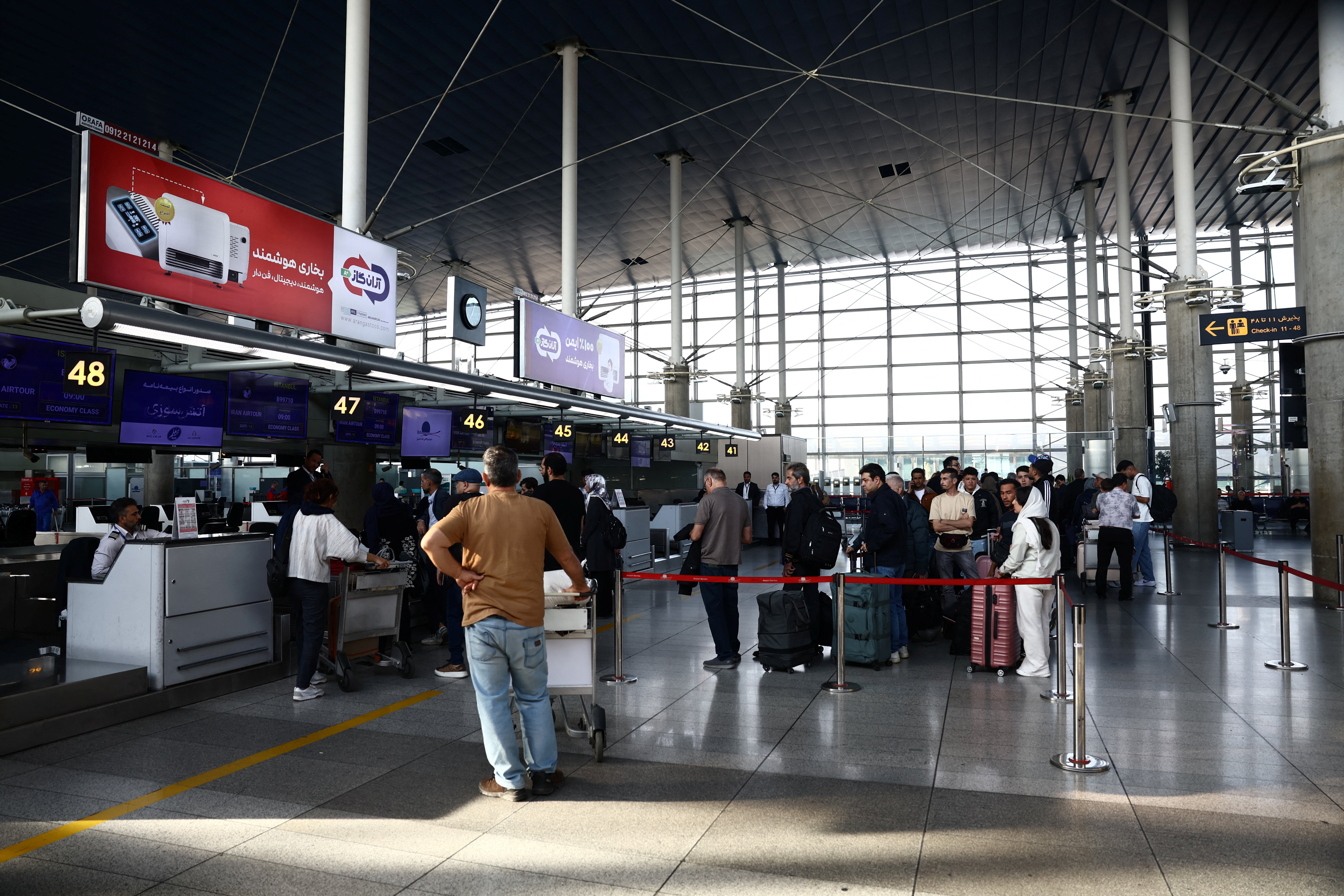 Passengers check in for flights at Imam Khomeini International Airport near Tehran during a ceasefire in the US-Israel war on Iran on April 25, 2026