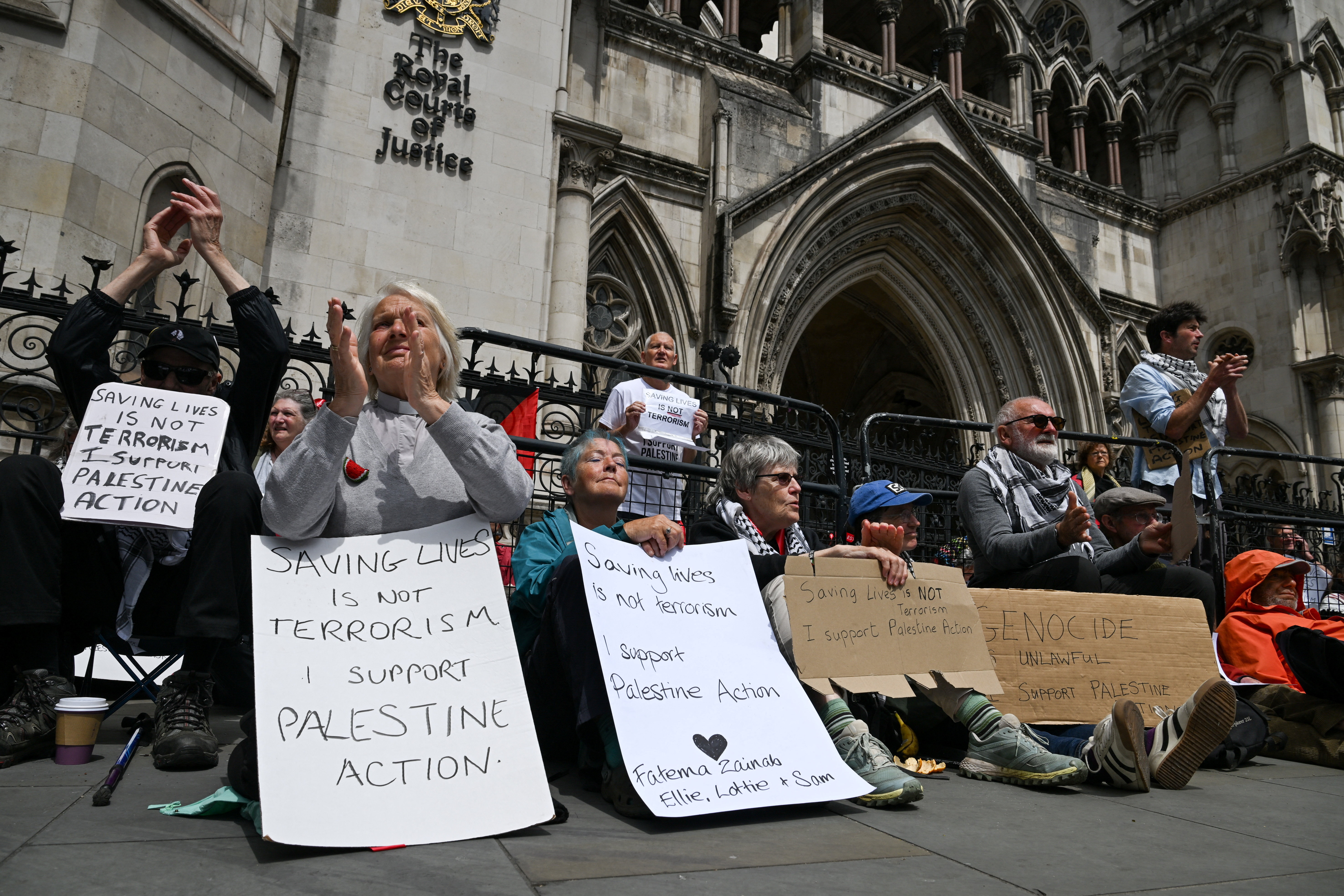 People attend a demonstration opposing the government's decision to ban Palestine Action as a terror organisation, following a Court of Appeal ruling on the lawfulness of proscribing the pro-Palestinian group under terrorism laws, outside the Royal Courts of Justice, in London, Britain, June 15, 2026. REUTERS/Chris J. Ratcliffe