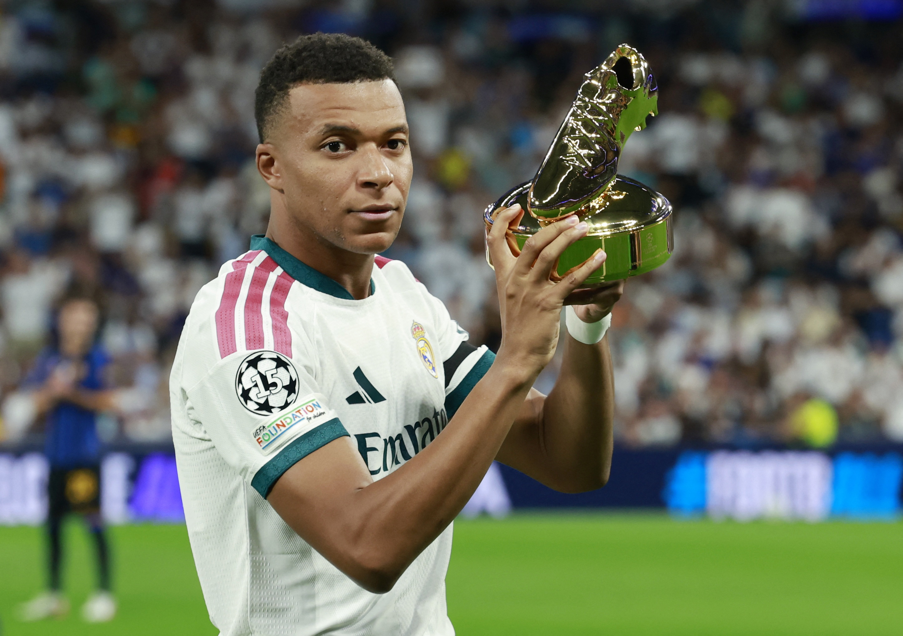 Real Madrid's Kylian Mbappe holds up the UEFA Champions League 2025/26 golden boot award.