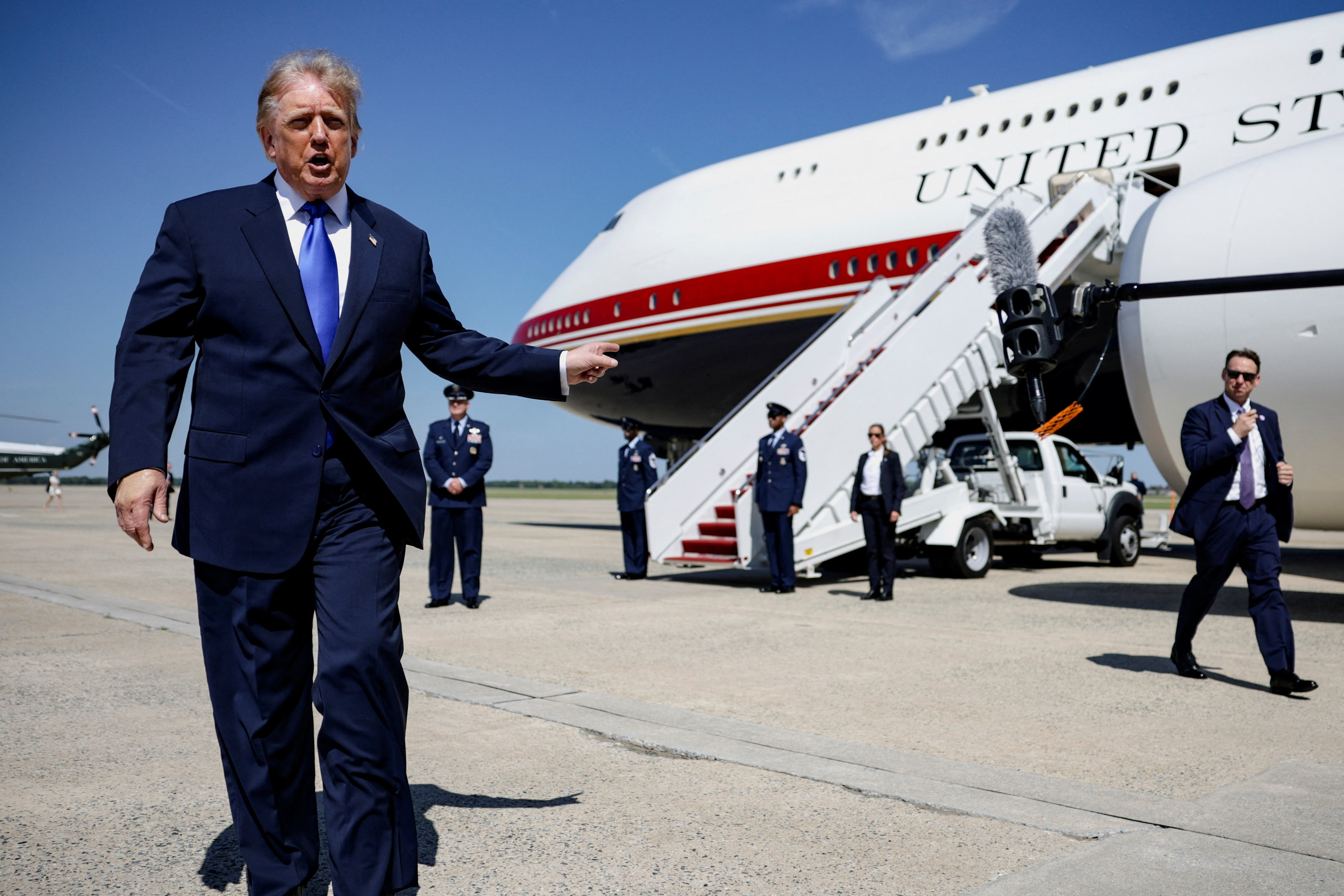 U.S. President Donald Trump walks to speak to the media before boarding Air Force One for a trip to the Republican National Midterm Convention, at Joint Base Andrews, Maryland