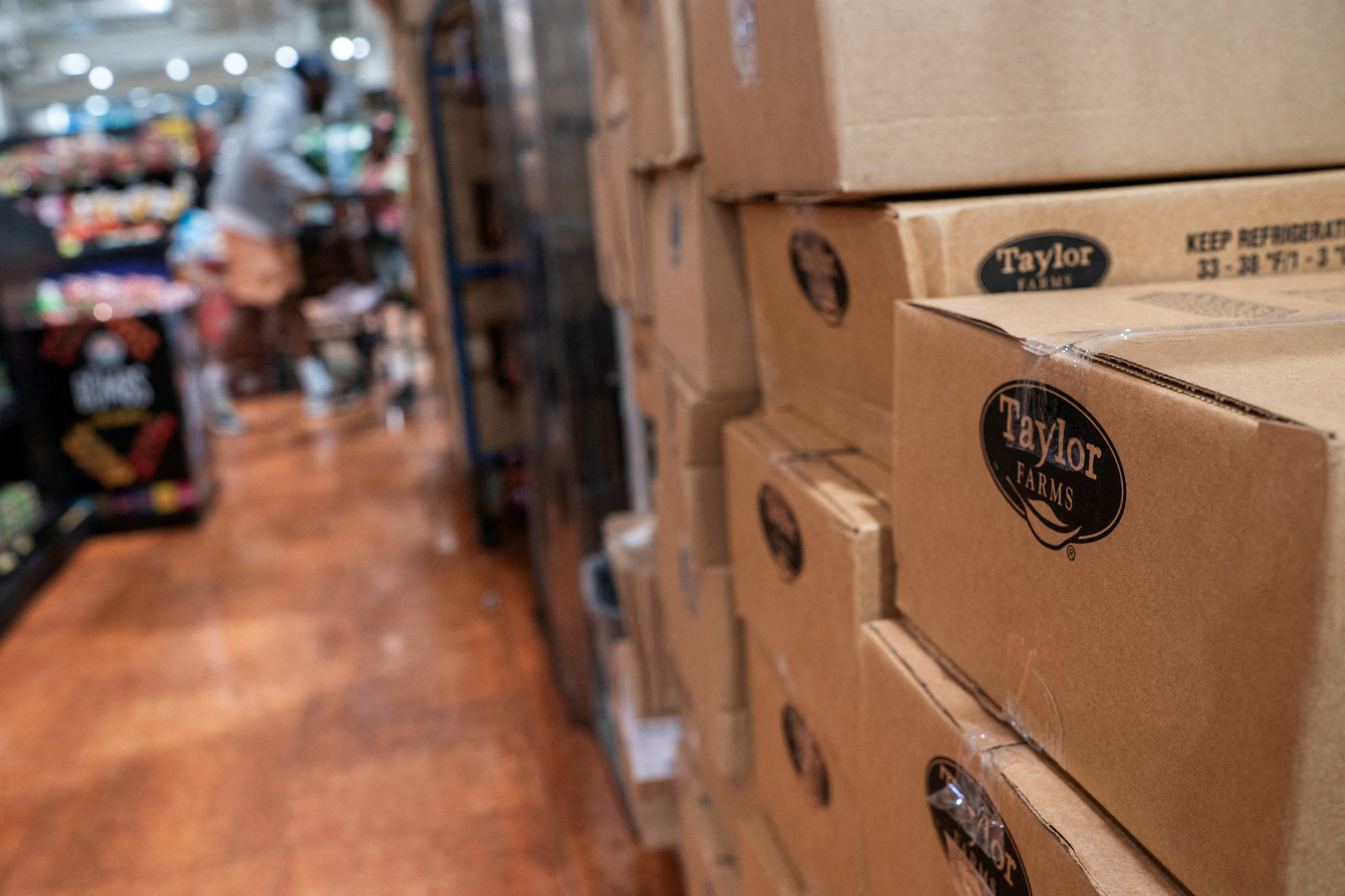 Boxes of Taylor Farms Lettuce sit stacked amid reports of slumping consumer confidence in lettuce and other fresh produce during the current cyclosporiasis outbreak that has sickened thousands across the U.S., at a grocery store in Washington, D.C., U.S., July 24, 2026. REUTERS/Nathan Howard/File Photo