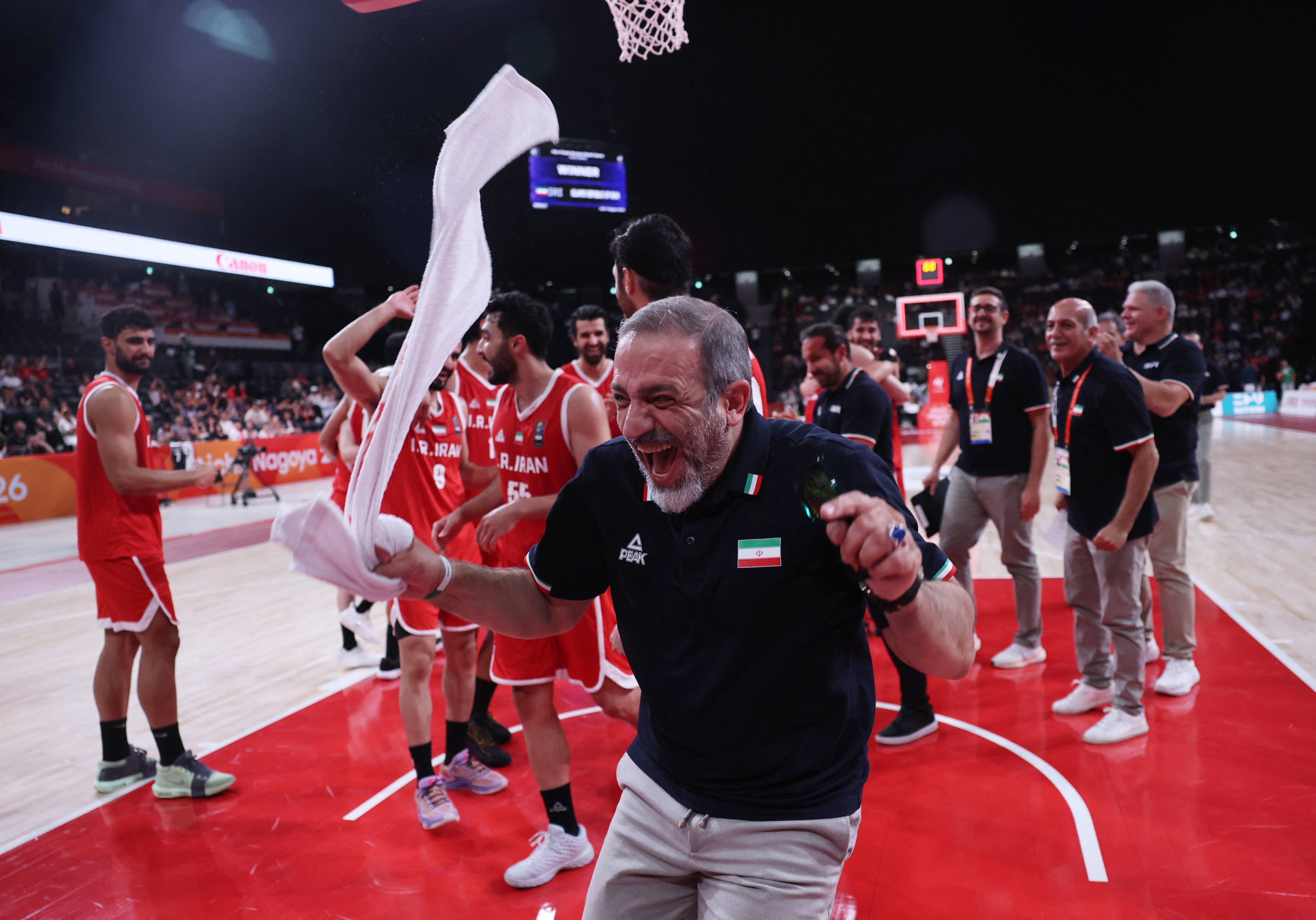Asian Games - Aichi-Nagoya 2026 - Basketball - Men's - Bronze Medal Match - China v Iran - Aichi International Arena, Nagoya, Japan - September 20, 2026 A member of Iran's coaching staff celebrates after winning bronze in the Men's Basketball REUTERS/Anushree Fadnavis