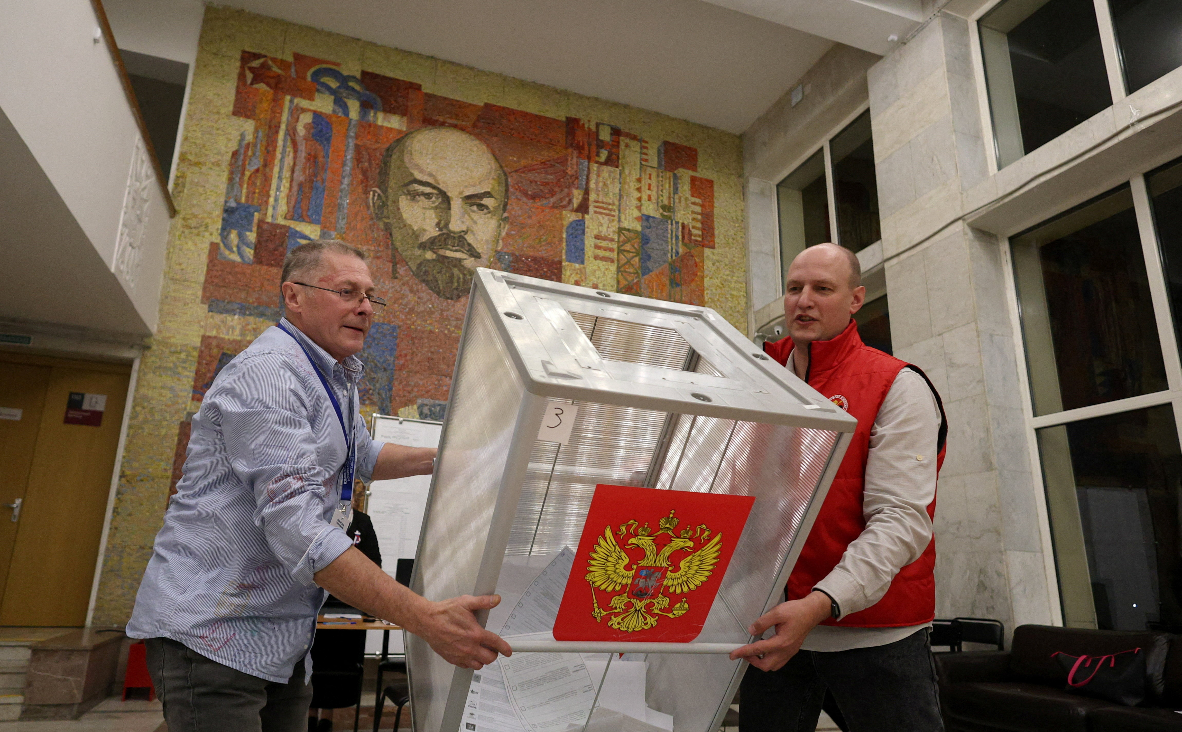 Electoral commission members empty a ballot box onto a table in Podolsk, near Moscow