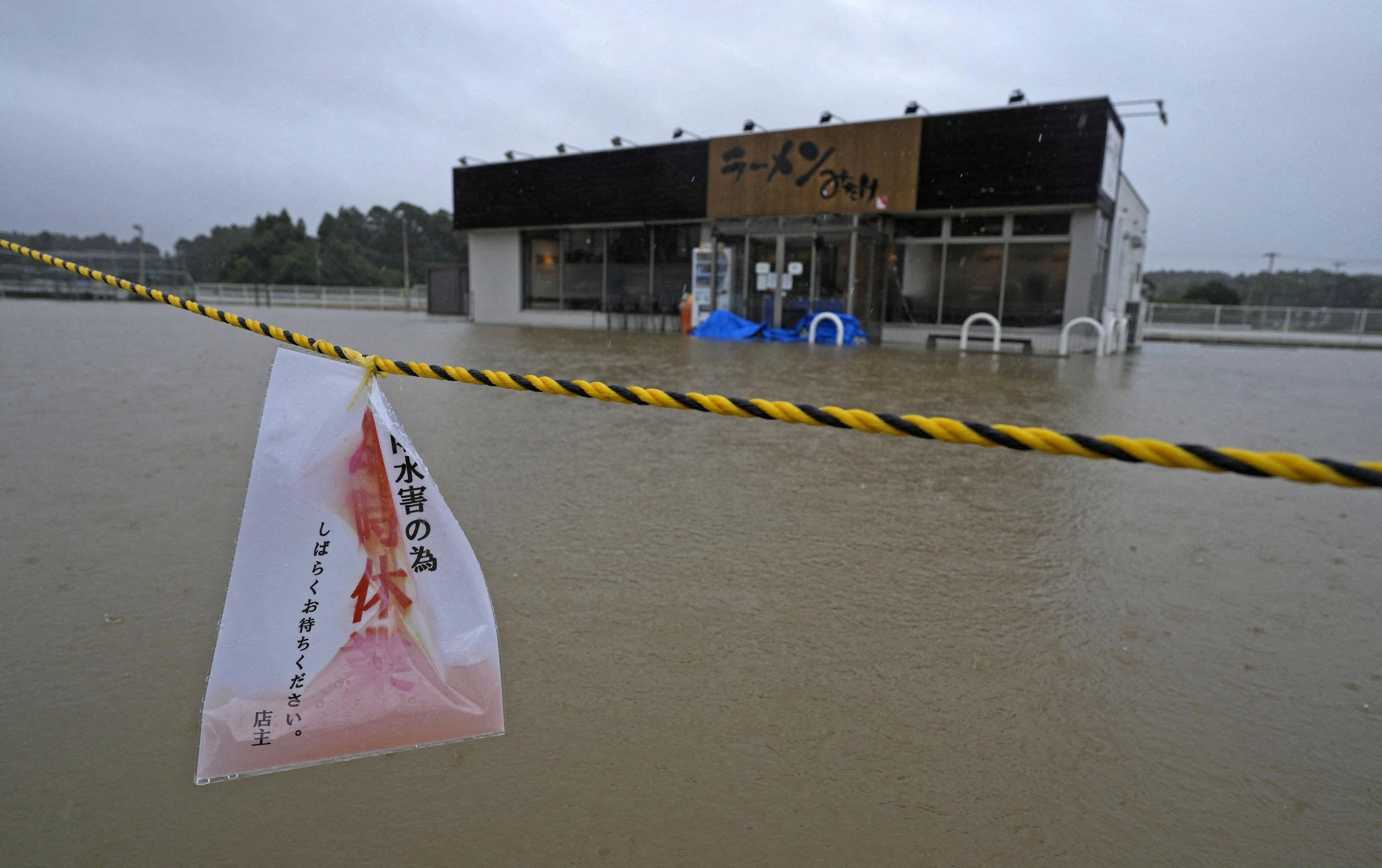 The area around a ramen restaurant is flooded by heavy rain as Typhoon Dujuan approaches Oamishirasato, Japan, September 21, 2026