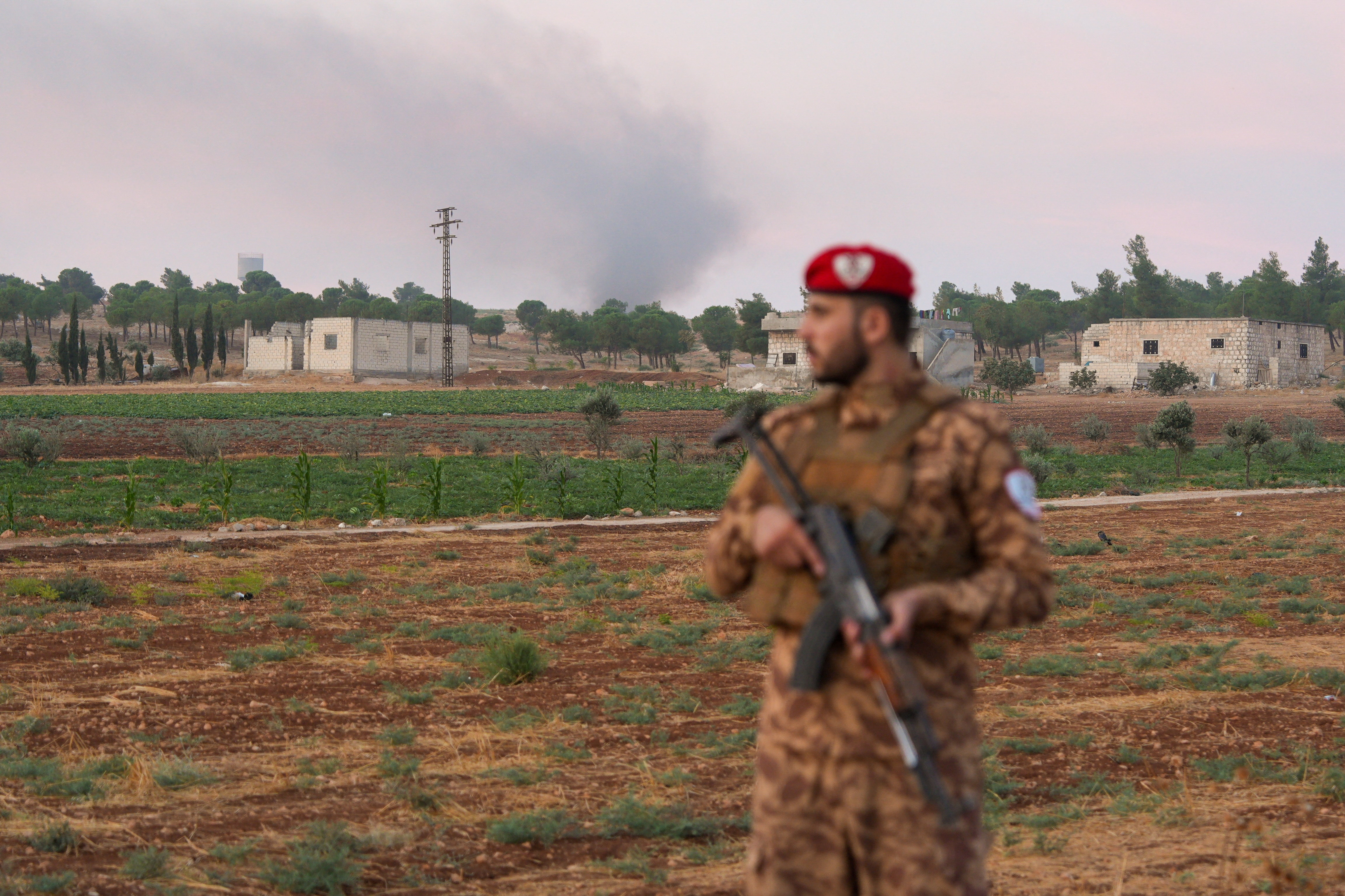 A military police officer stands on a road following an explosion at a weapons depot in the Al-Eis area, in the southern countryside of Aleppo, Syria, September 21, 2026. REUTERS/Karam al-Masri