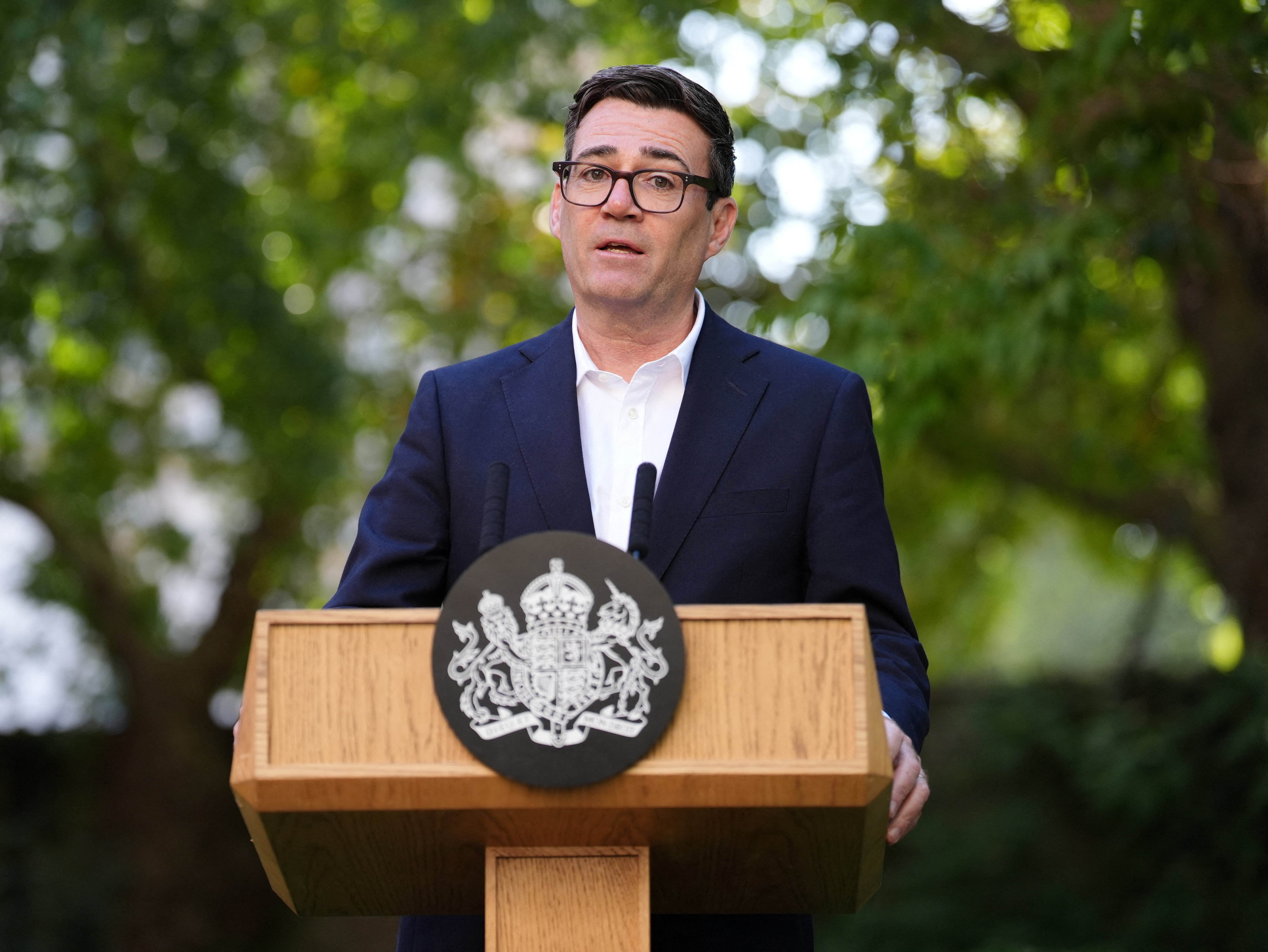 Andy Burnham speaking at a lectern inside 10 Downing Street
