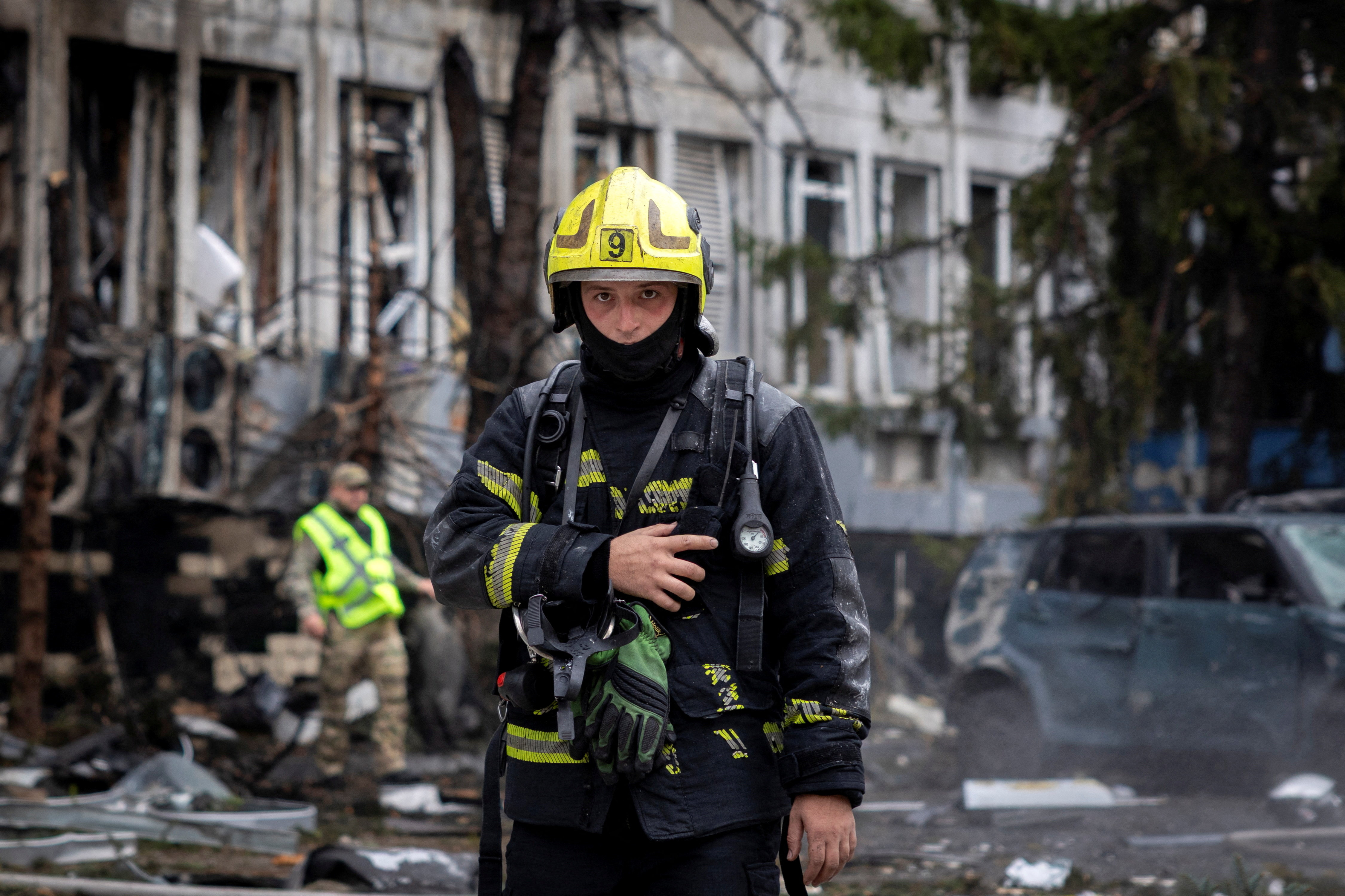 A firefighter works at the site of a business center that was struck by a Russian drone, amid Russia's attack on Ukraine in Kyiv, Ukraine September 23, 2026. REUTERS/Thomas Peter TPX IMAGES OF THE DAY