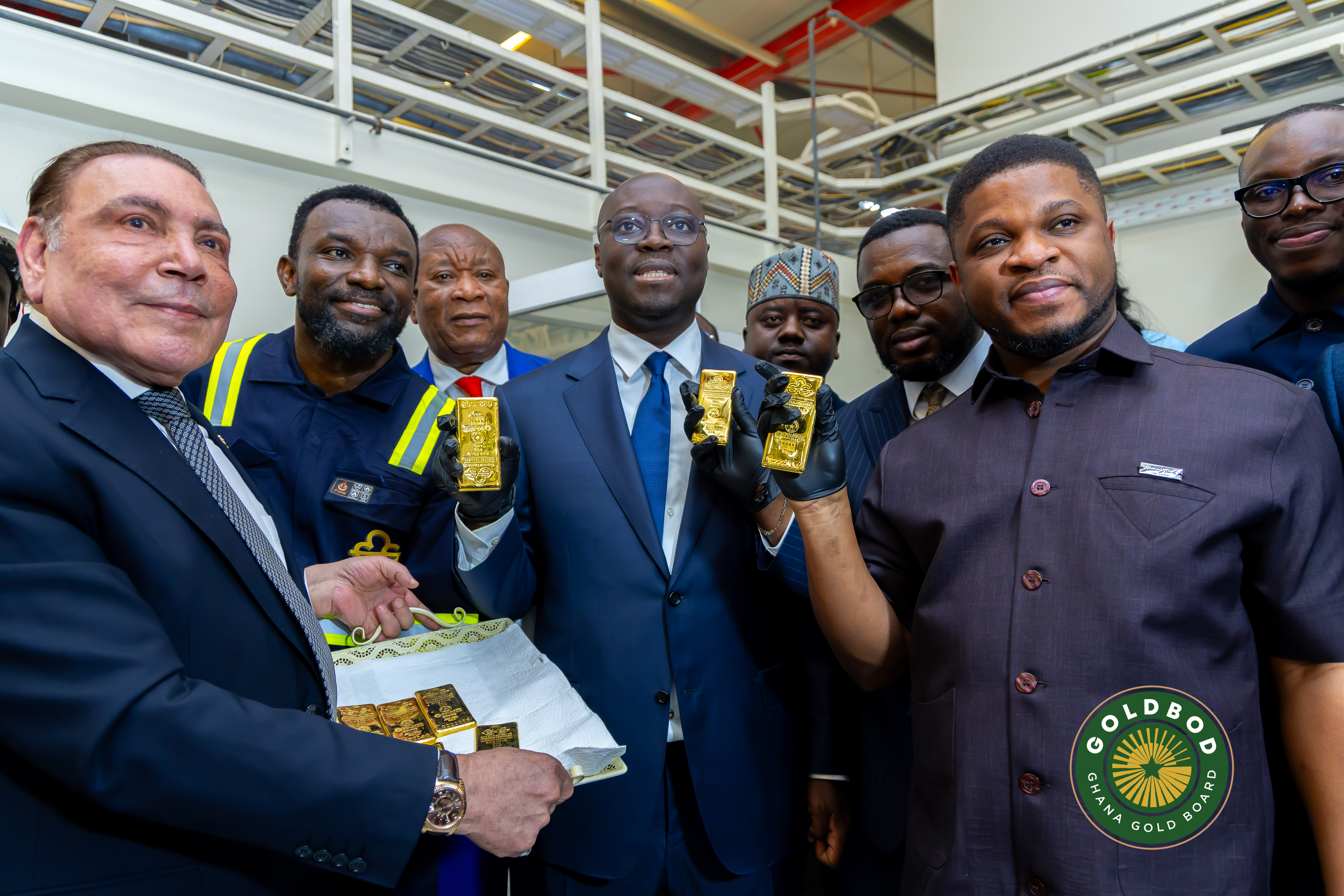Ghana’s Finance Minister Cassiel Ato Baah Forson, centre, and GoldBod CEO Sammy Gyamfi, second right, hold refined gold bars during a visit to Gold Coast Refinery [Courtesy of Ghana GoldBod]