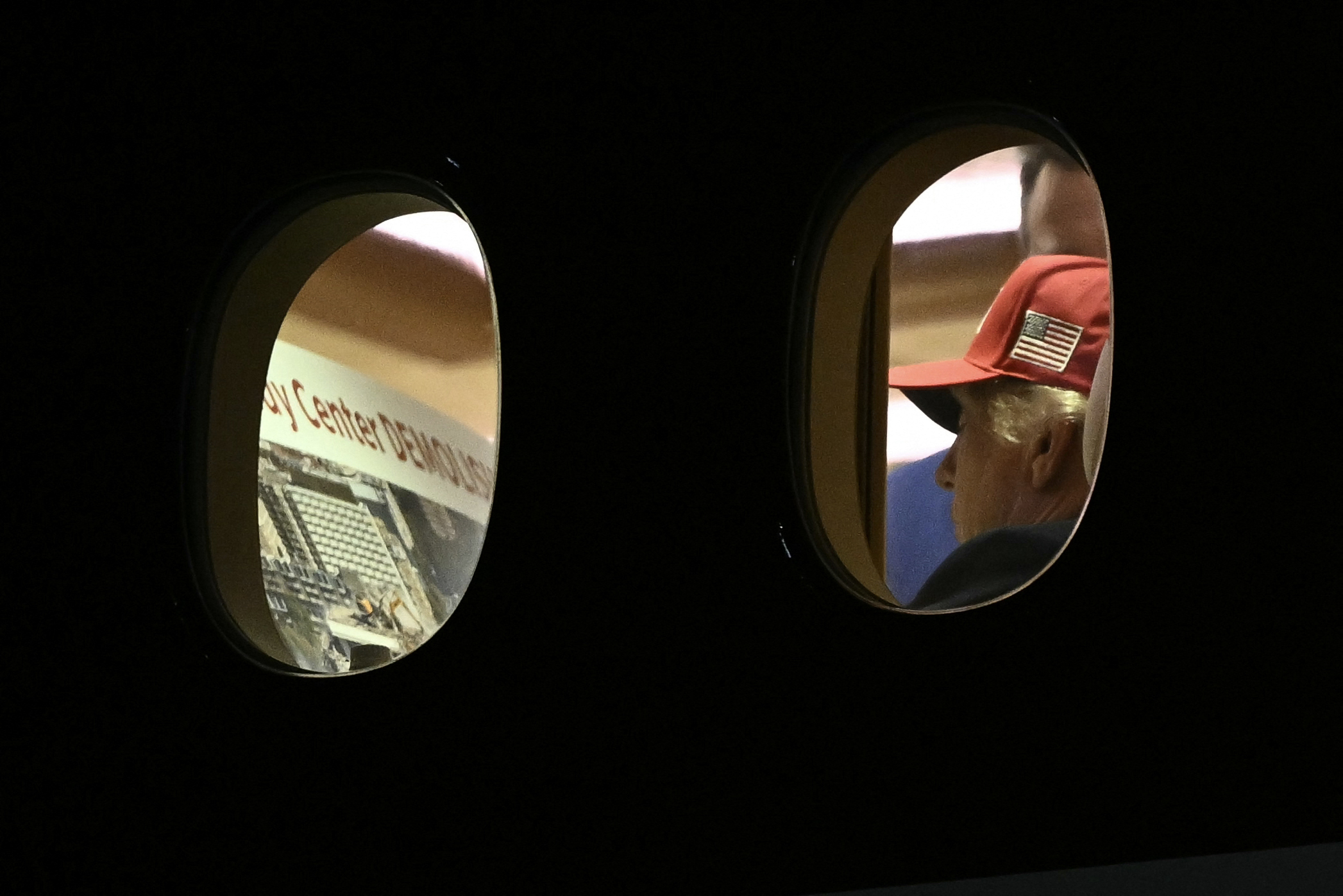 US President Donald Trump is seen aboard Air Force One checking a Kennedy Center large printout after landing at Joint Base Andrews, Maryland on September 16, 2026. Trump, who is returning from Gastonia, North Carolina after campaigning for Republican US Senate candidate Michael Whatley, threatened on September 15, 2026 to keep the Kennedy Center closed for good after a judge ruled his name cannot be added onto the famed arts institution's facade. (Photo by Brendan SMIALOWSKI / AFP)