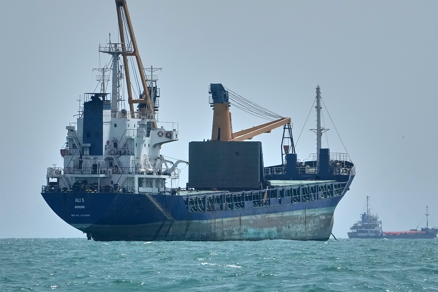 A general cargo ship lies anchored among other commercial vessels in the Strait of Hormuz off Bandar Abbas, Iran, Sunday, Sept. 6, 2026. (AP Photo/Vahid Salemi)