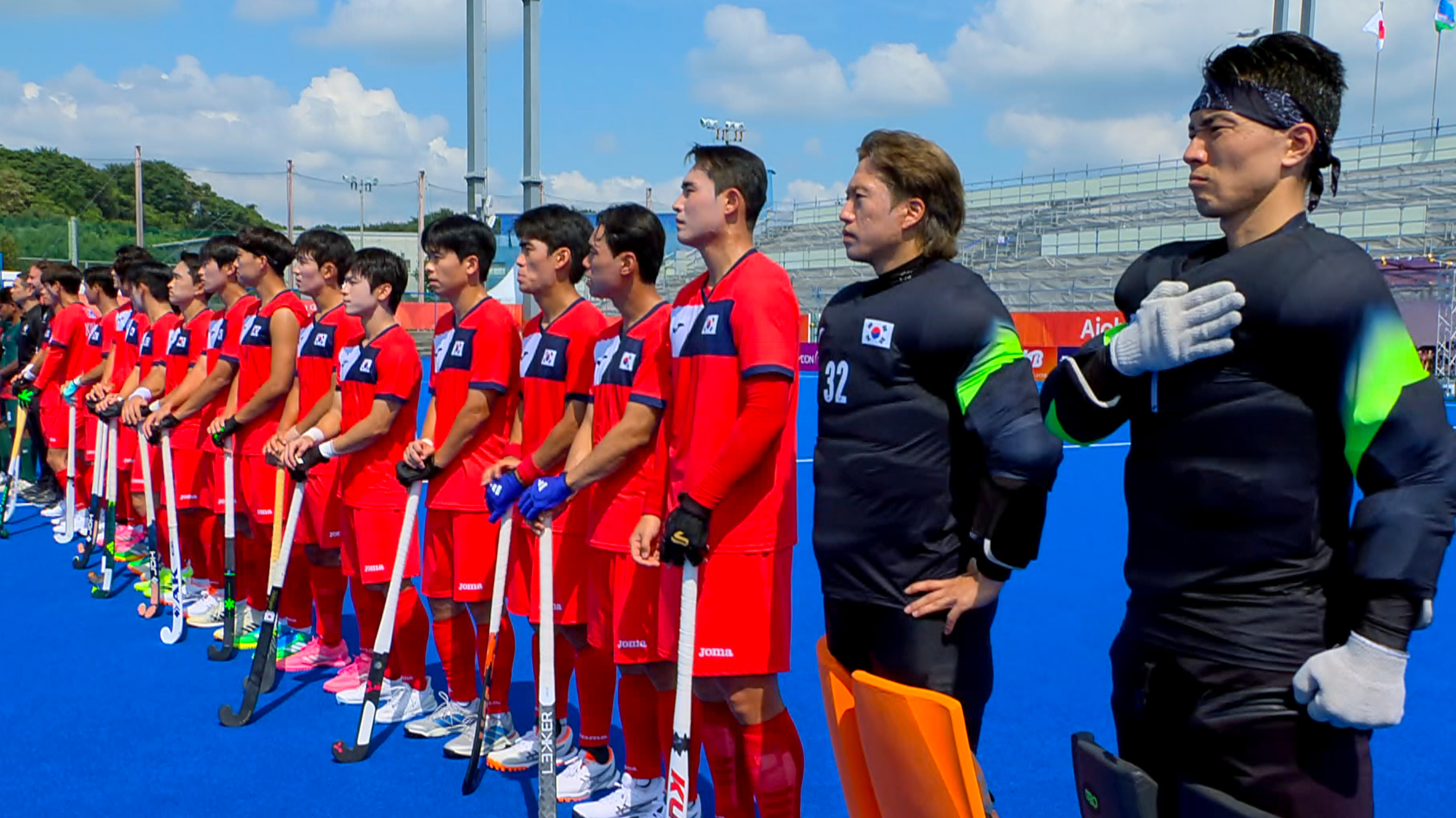 In this image made from video, South Korean men's field hockey players react as the North Korean national anthem is played ahead of their game against Bangladesh at the Asian Games