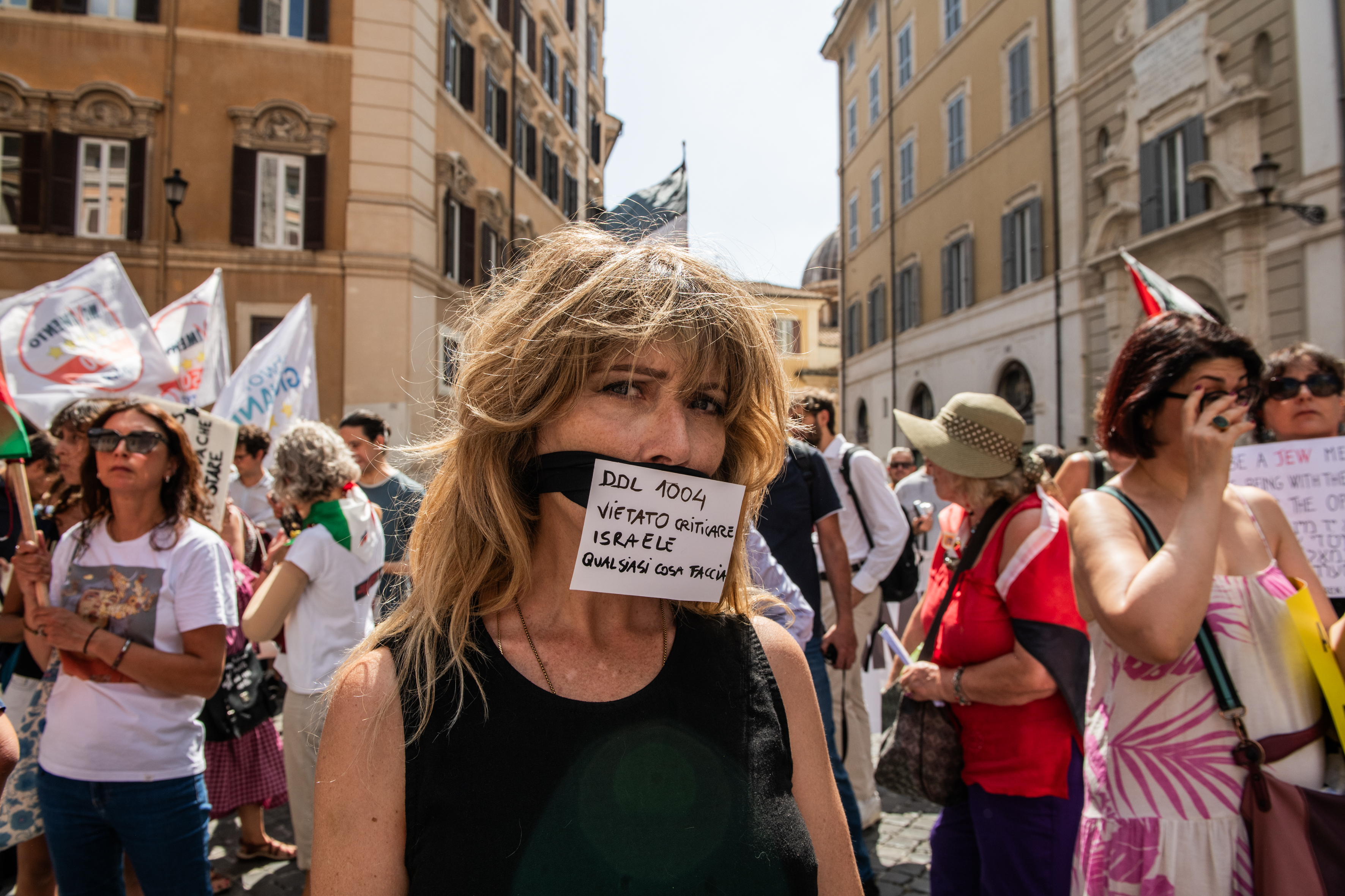 Rome, picket in front of Montecitorio, seat of the Chamber of Deputies, to protest against the new "antisemitism bill", that wants to rewrite the definition of antisemitism, largely criticized for its potential criminalisation of the Pro Palestinian movement. In the picture: A woman with taped mouth and a sign saying "bill 1004 forbidden criticisin israel, whatever it does".
