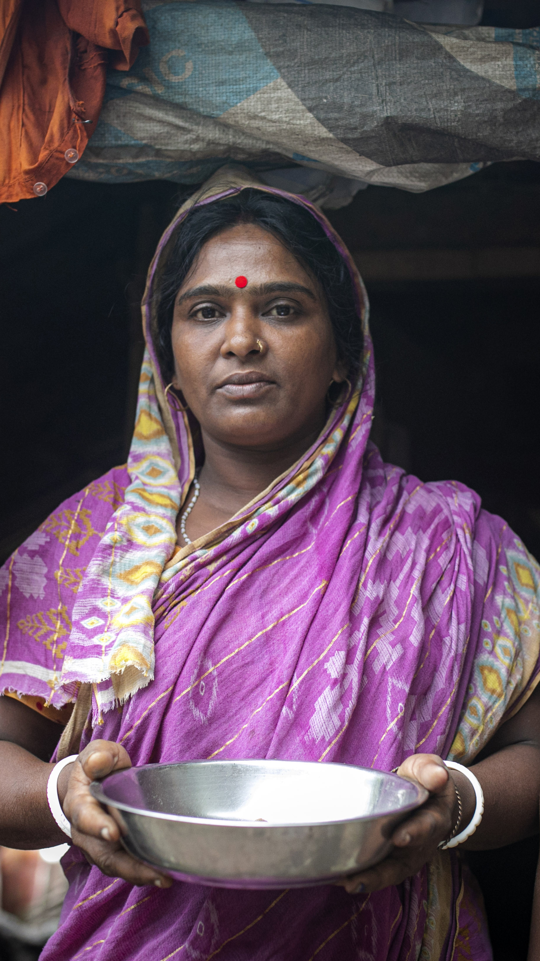 Deepa Mandol with her six-year-old son at their home in Koyra