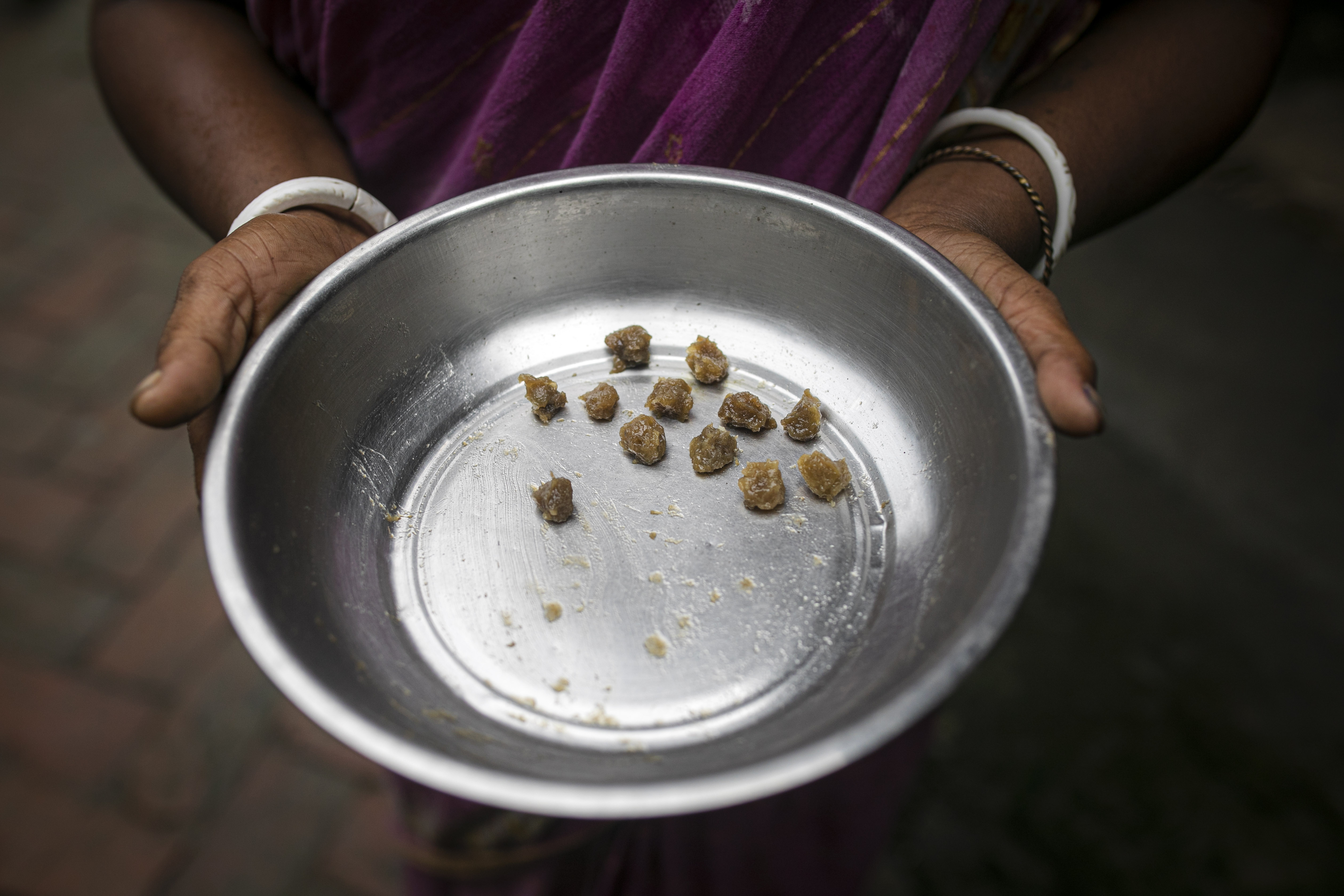 Pellets of herbal medicine that Deepa Mandol gives to her husband, who has hepatitis B, as part of his traditional care