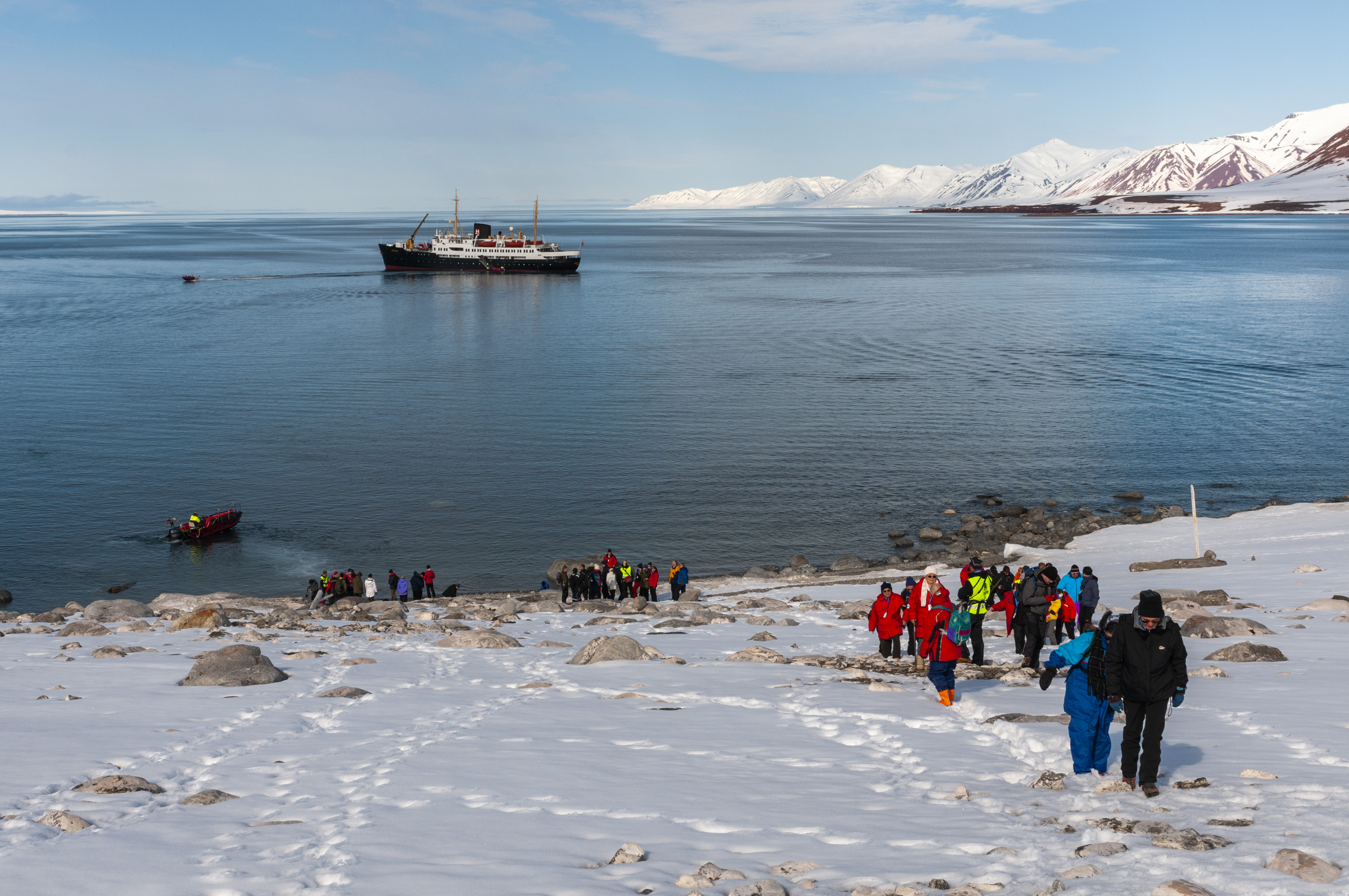Expedition cruise ship tourists explore the Bockfjorden's shore