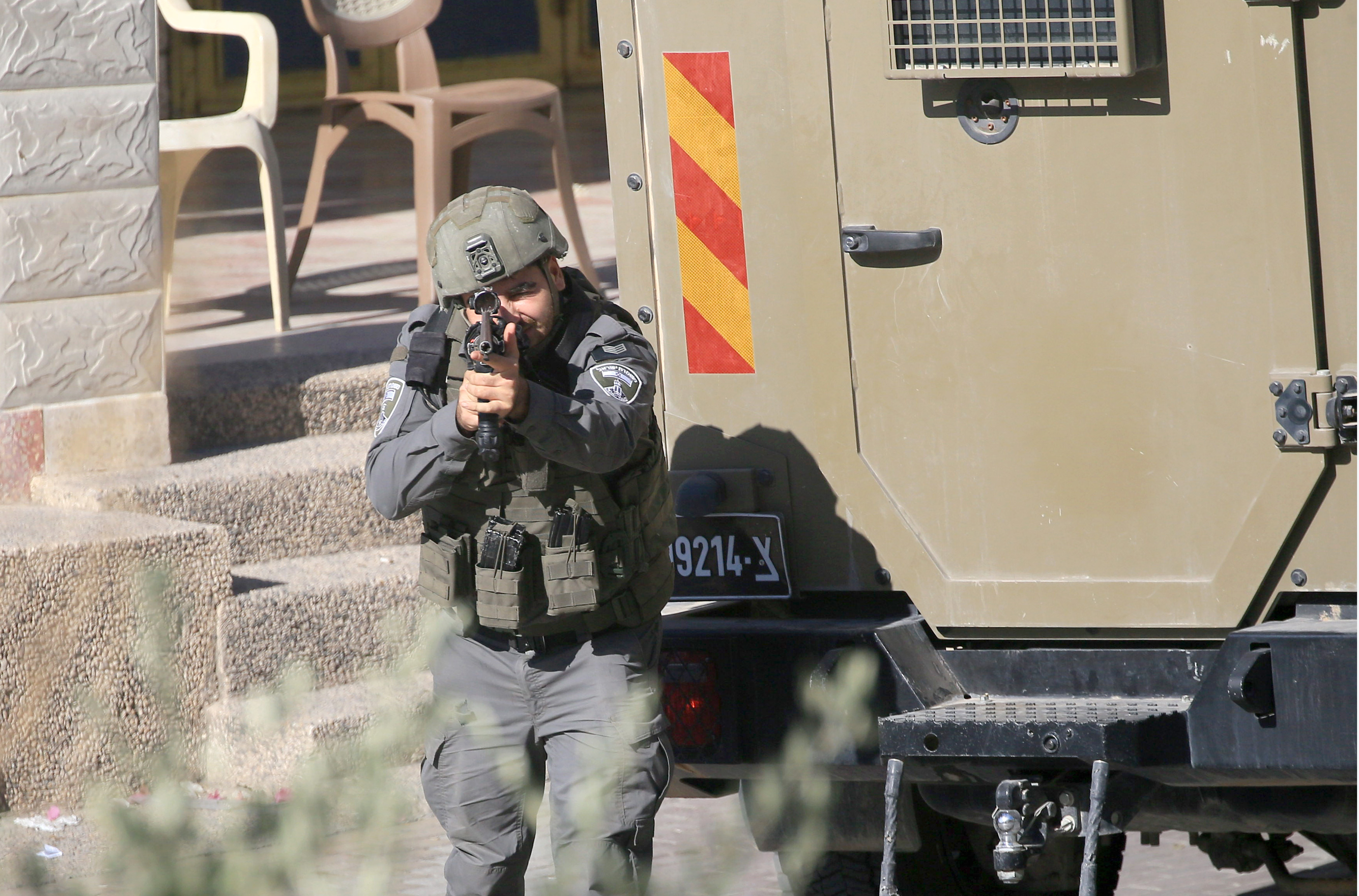 An Israeli soldier points his rifle