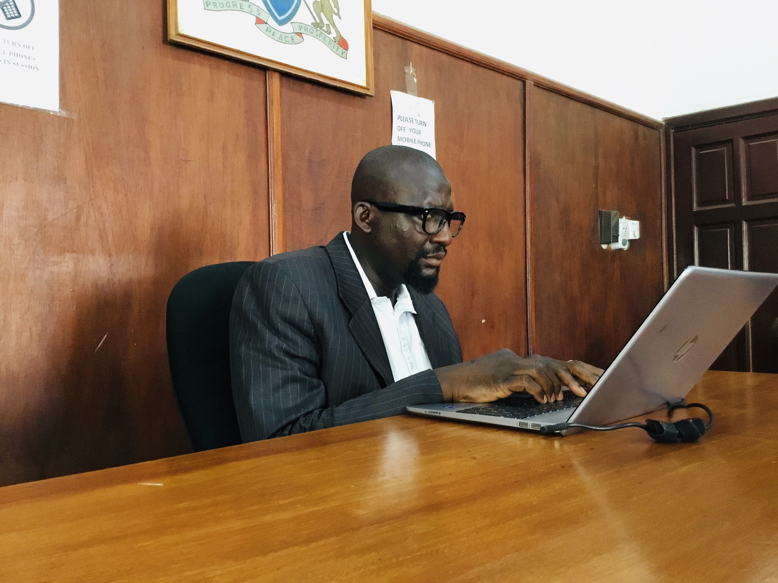 Magistrate Krubally follows proceedings on his computer in the courtroom