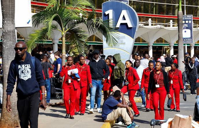 Passengers and airline crew gather outside an airport during a two-day strike that disrupted aviation services across Kenya [Hafsa Sheikh/Al Jazeera]
